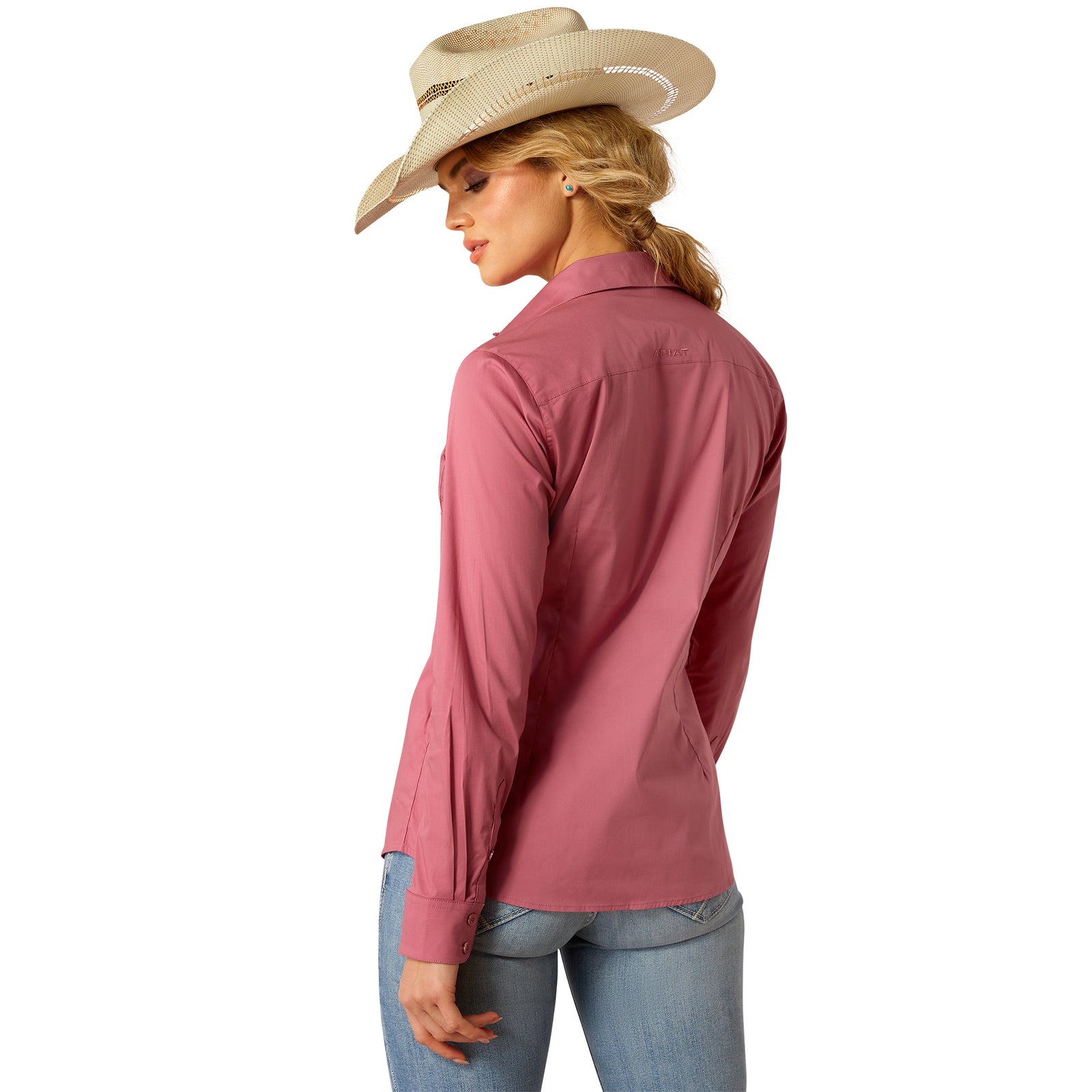 Ariat Women's Wrinkle Resistant Kirby Stretch L/S Western Shirt. Woman wearing a pink shirt and cowboy hat on a white background