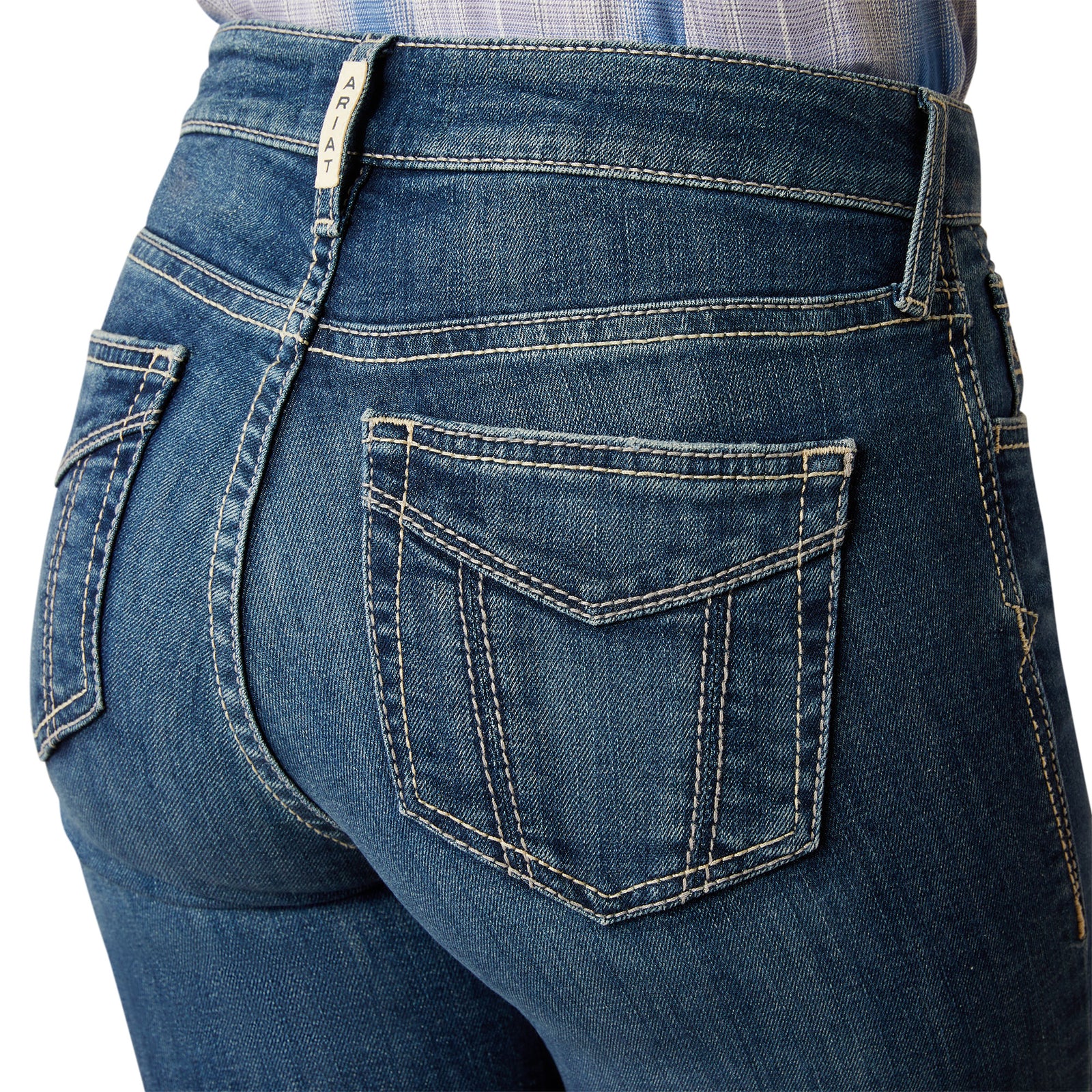 Ariat Women's Paula High Rise Slim Trouser. Close-up of blue jeans with a focus on the back pocket and stitching details.
