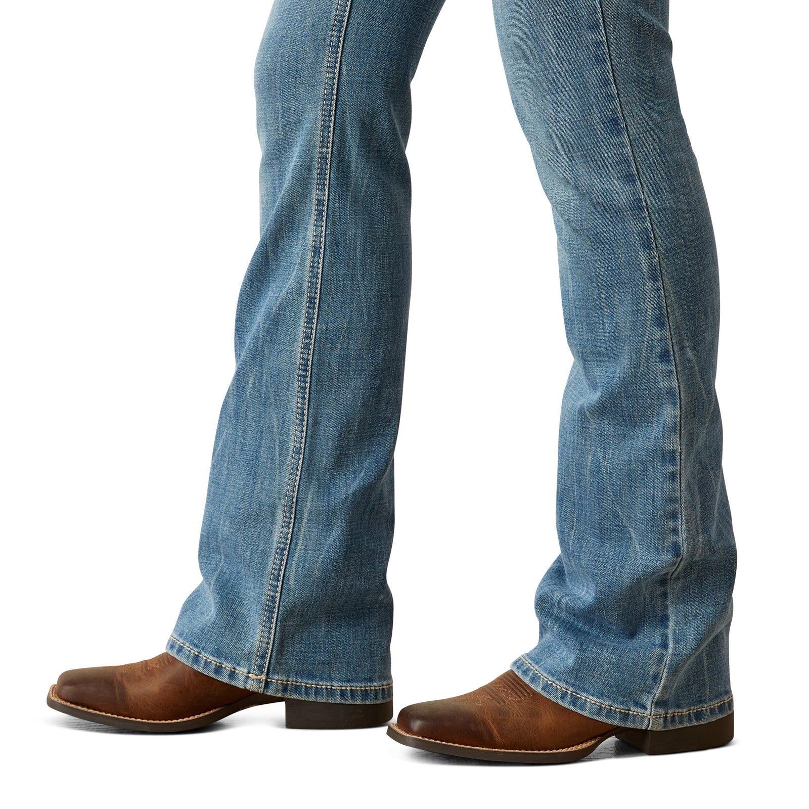 Ariat Women's Naz Perfect Rise Boot Cut Jean. Blue jeans and brown boots on a white background
