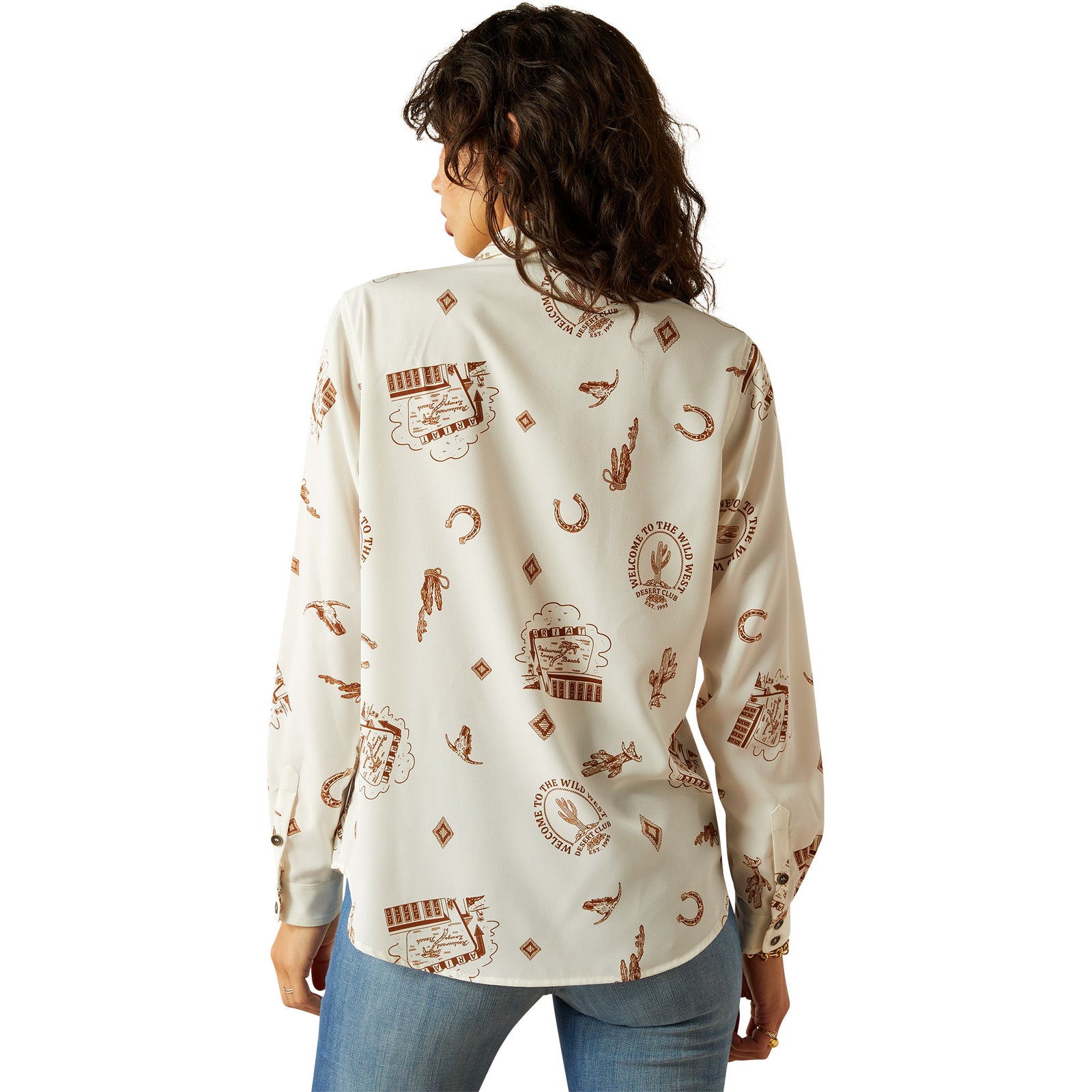 Ariat Women's Homestyle Button Up L/S Western Shirt. Woman wearing a cream-colored shirt with brown patterns on a white background