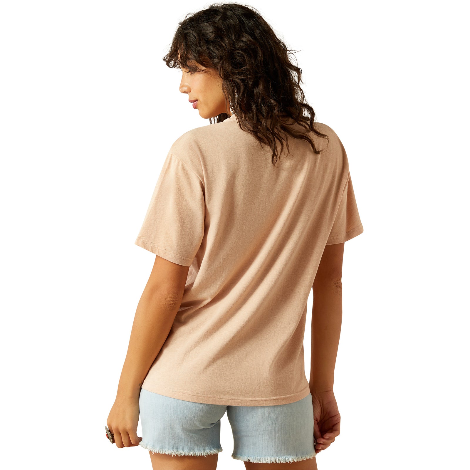 Ariat Women's Roadside T-Shirt. Woman wearing a beige t-shirt and light blue shorts on a white background