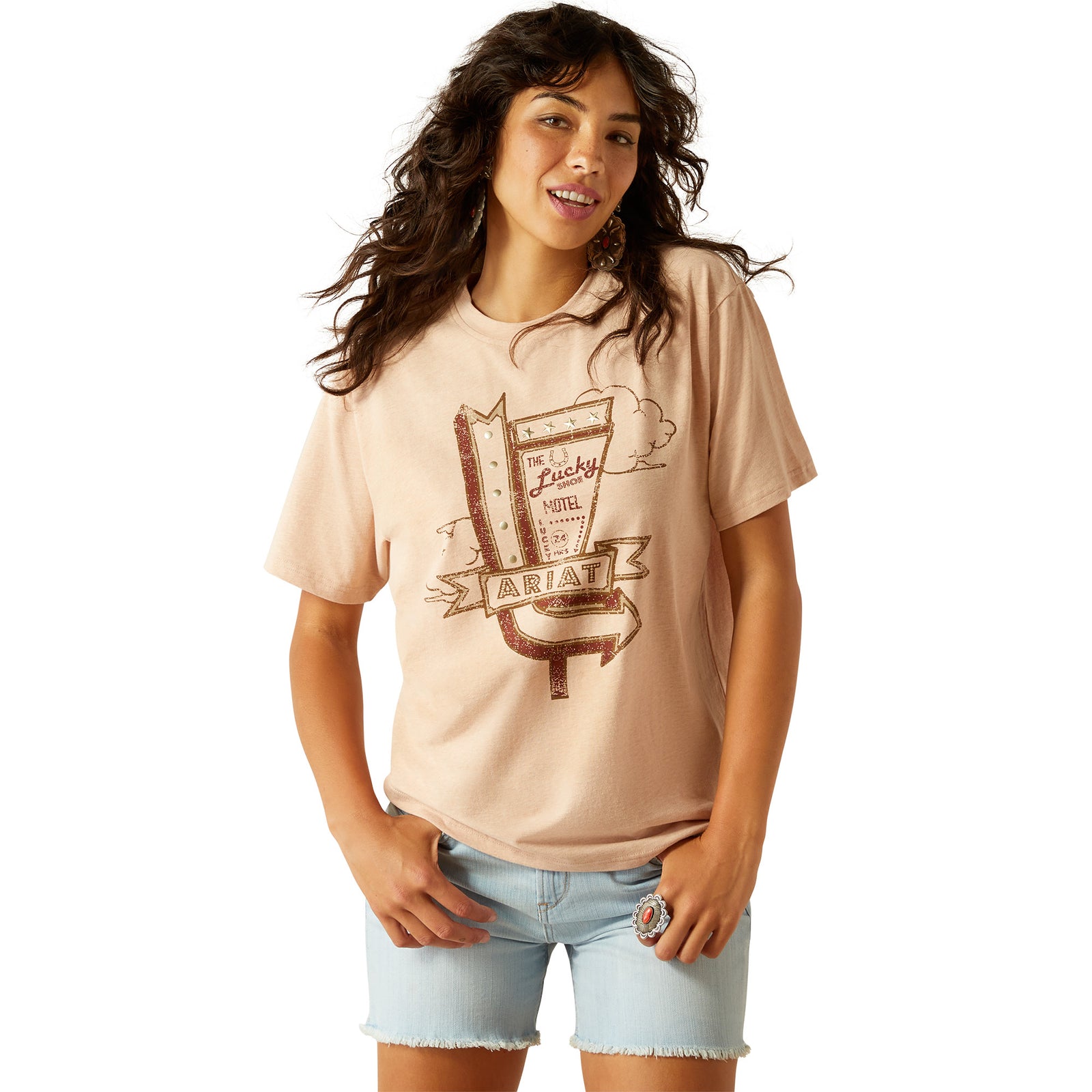 Ariat Women's Roadside T-Shirt. Woman wearing a beige t-shirt with graphic design on a white background