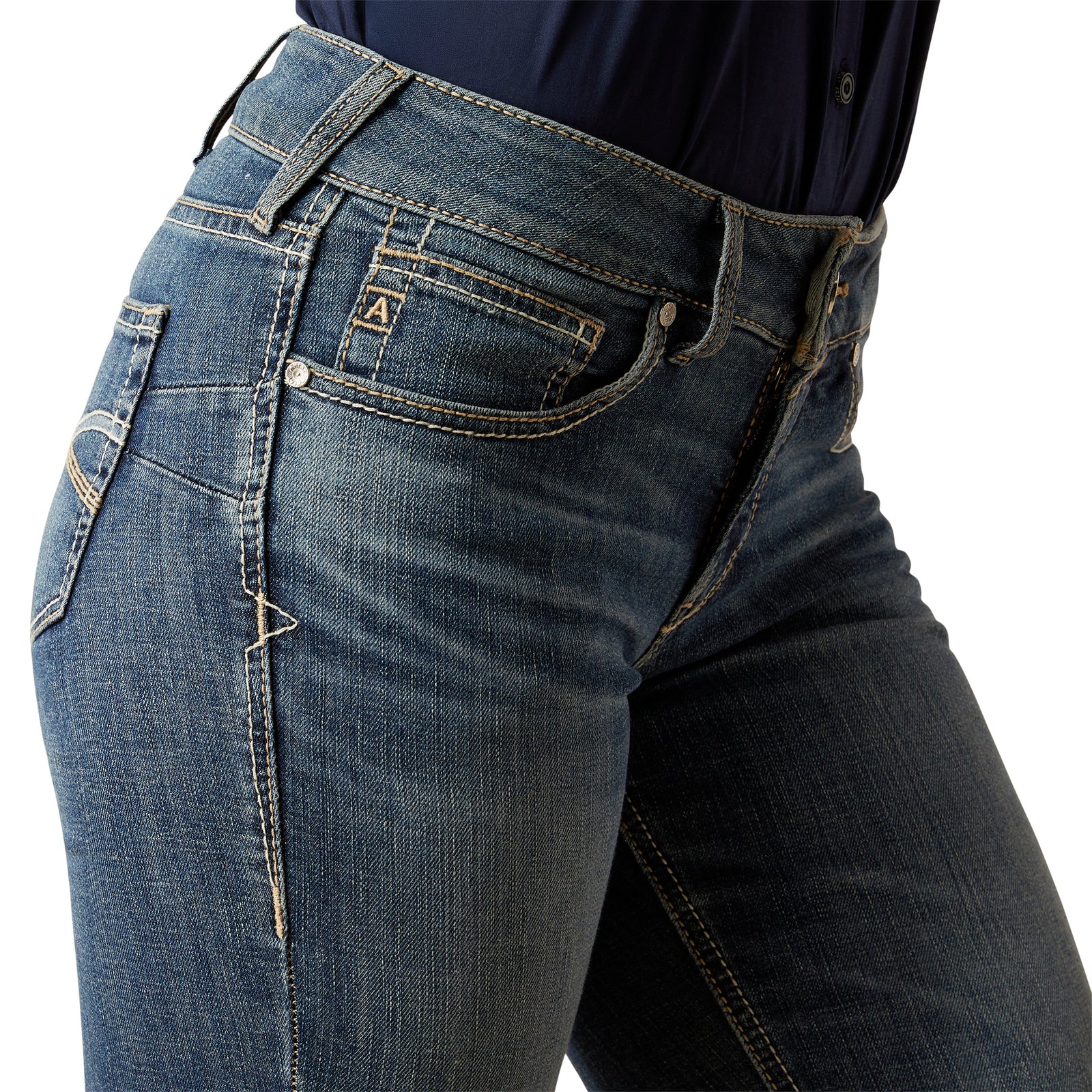 Ariat Women's Brydie Perfect Rise Boot Cut Jean. Close-up of blue jeans with a brand logo on a white background