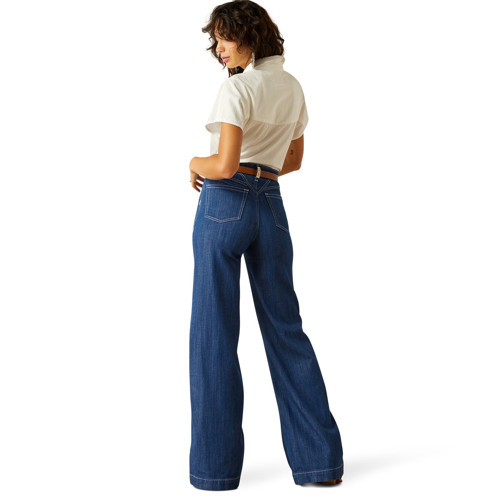 Ariat Women's Westie Ultra High-Rise Wide Leg Jean. Person wearing blue jeans and a white shirt on a white background