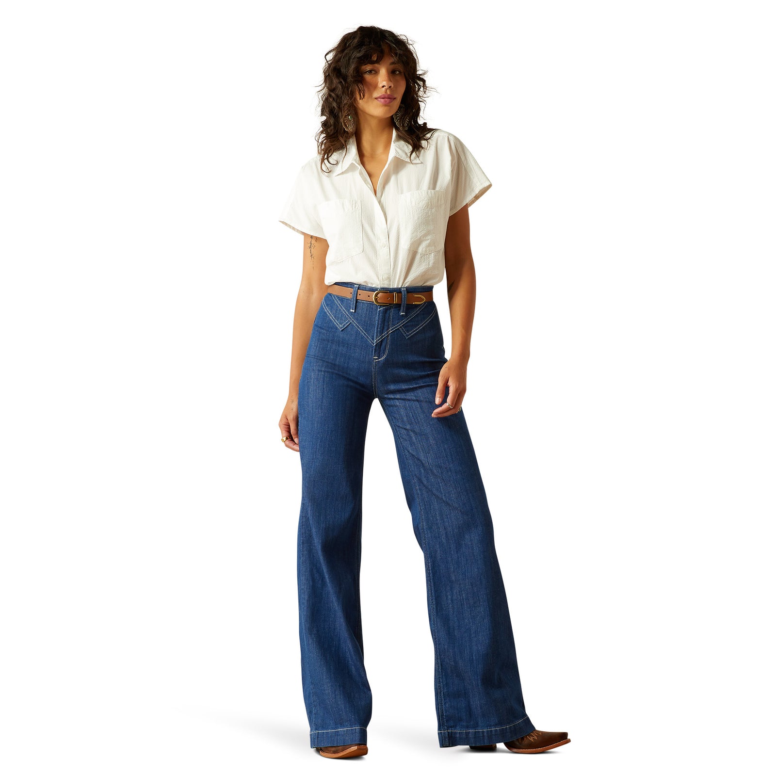 Ariat Women's Westie Ultra High-Rise Wide Leg Jean. Woman wearing a white blouse and blue jeans on a white background