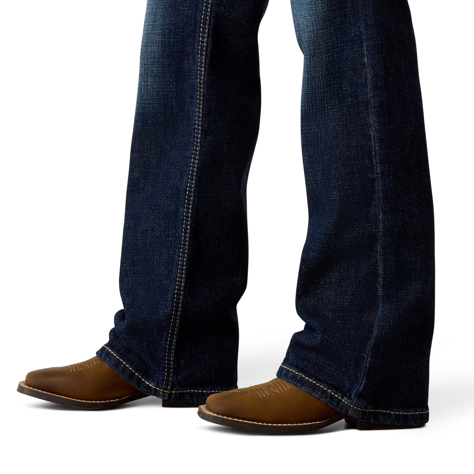 Close-up of blue jeans and brown shoes on a white background