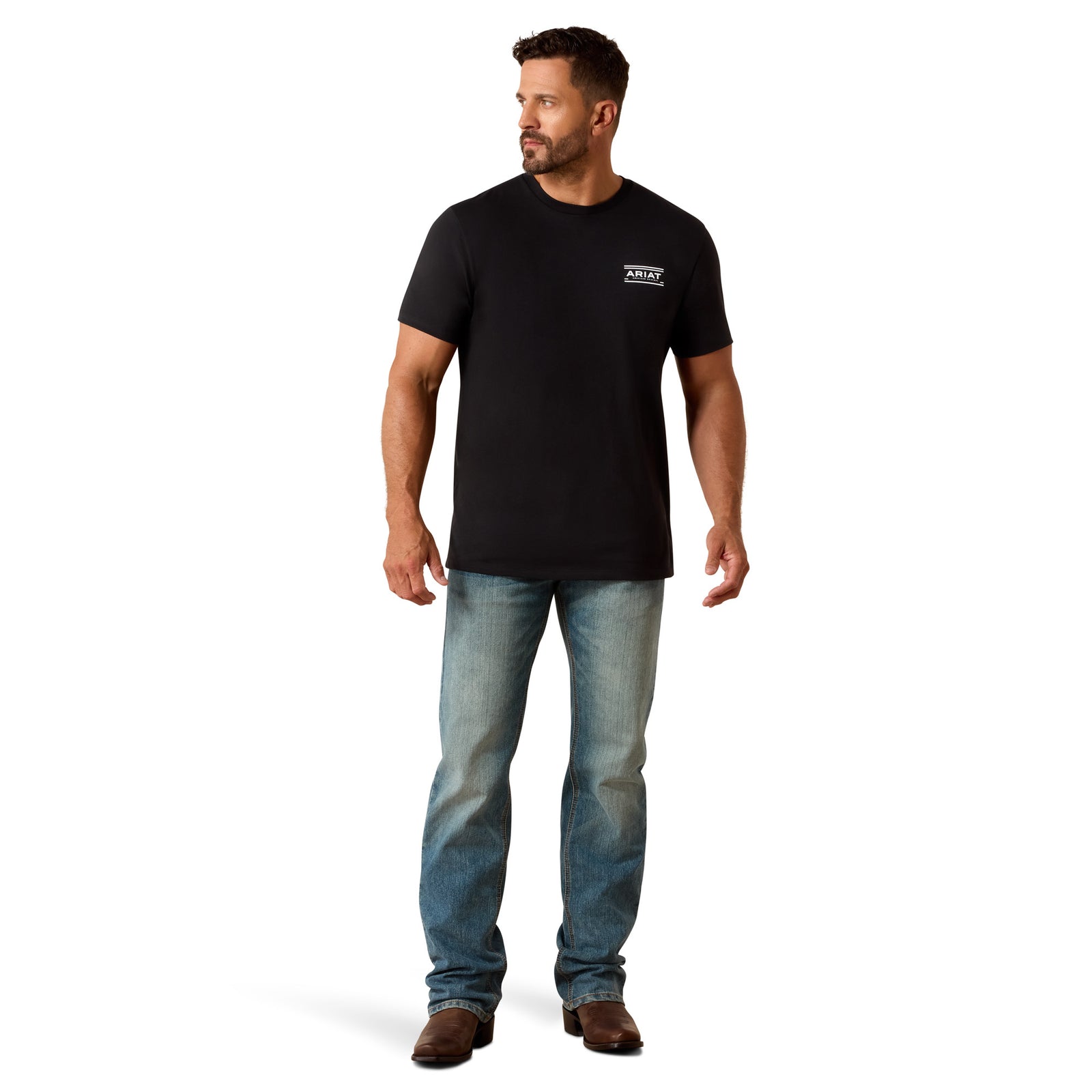 Man wearing a black t-shirt with a logo and blue jeans on a white background