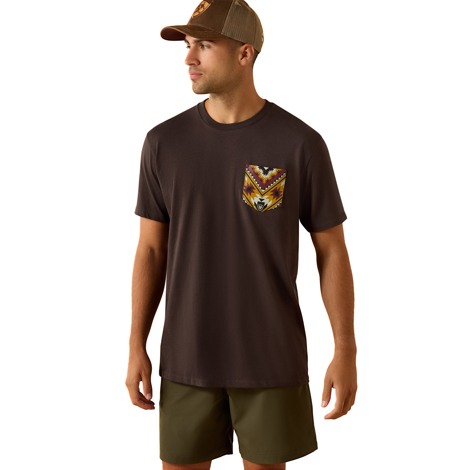 Man wearing a brown t-shirt with a pocket design and a cap on a white background