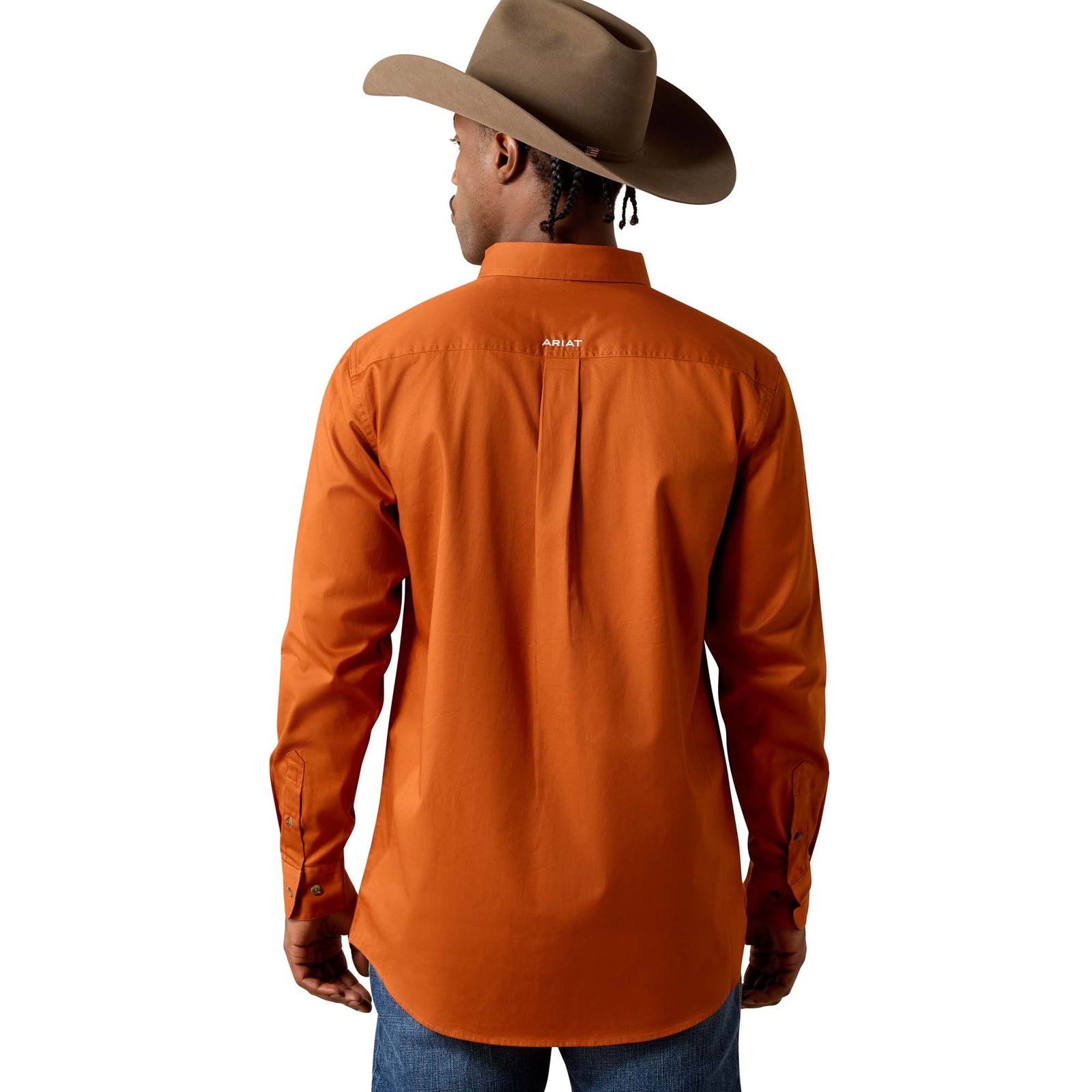 Person wearing an orange shirt and brown cowboy hat on a white background