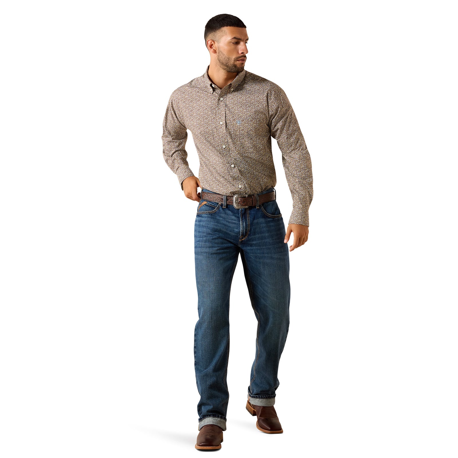 A man modeling a brown and beige patterned long-sleeve button-down shirt with blue jeans and brown boots, standing against a solid white background.