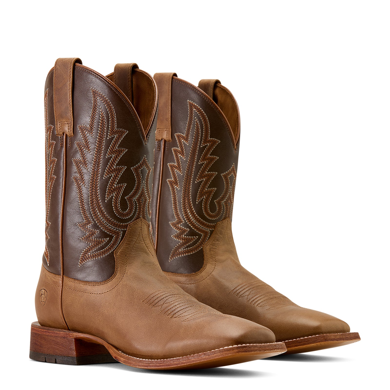 Pair of brown cowboy boots with intricate stitching on a white background