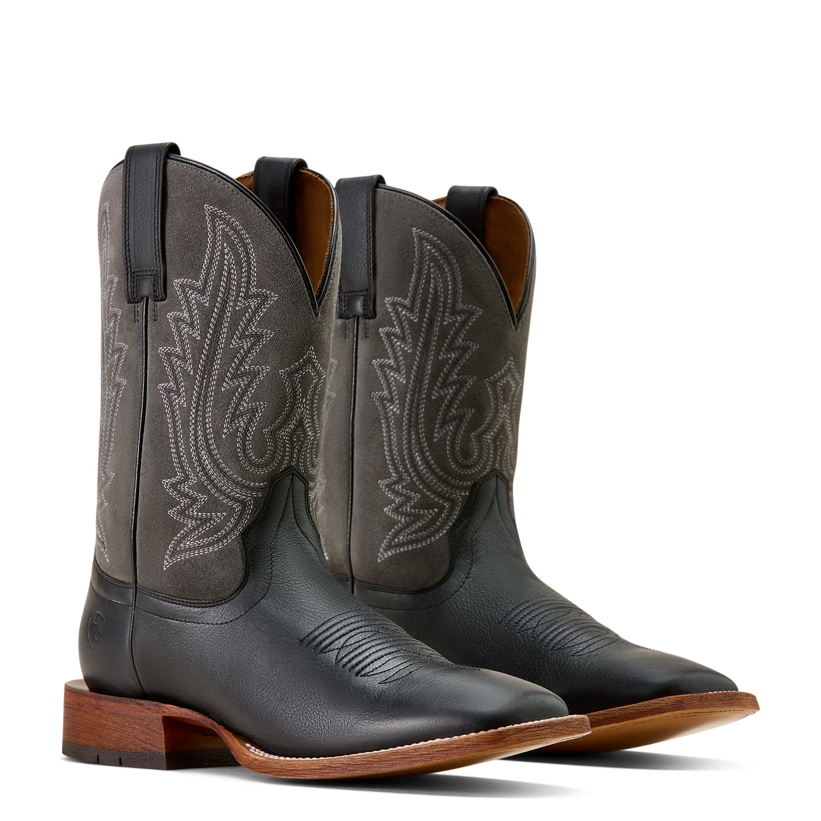 Pair of black cowboy boots with intricate designs on a white background