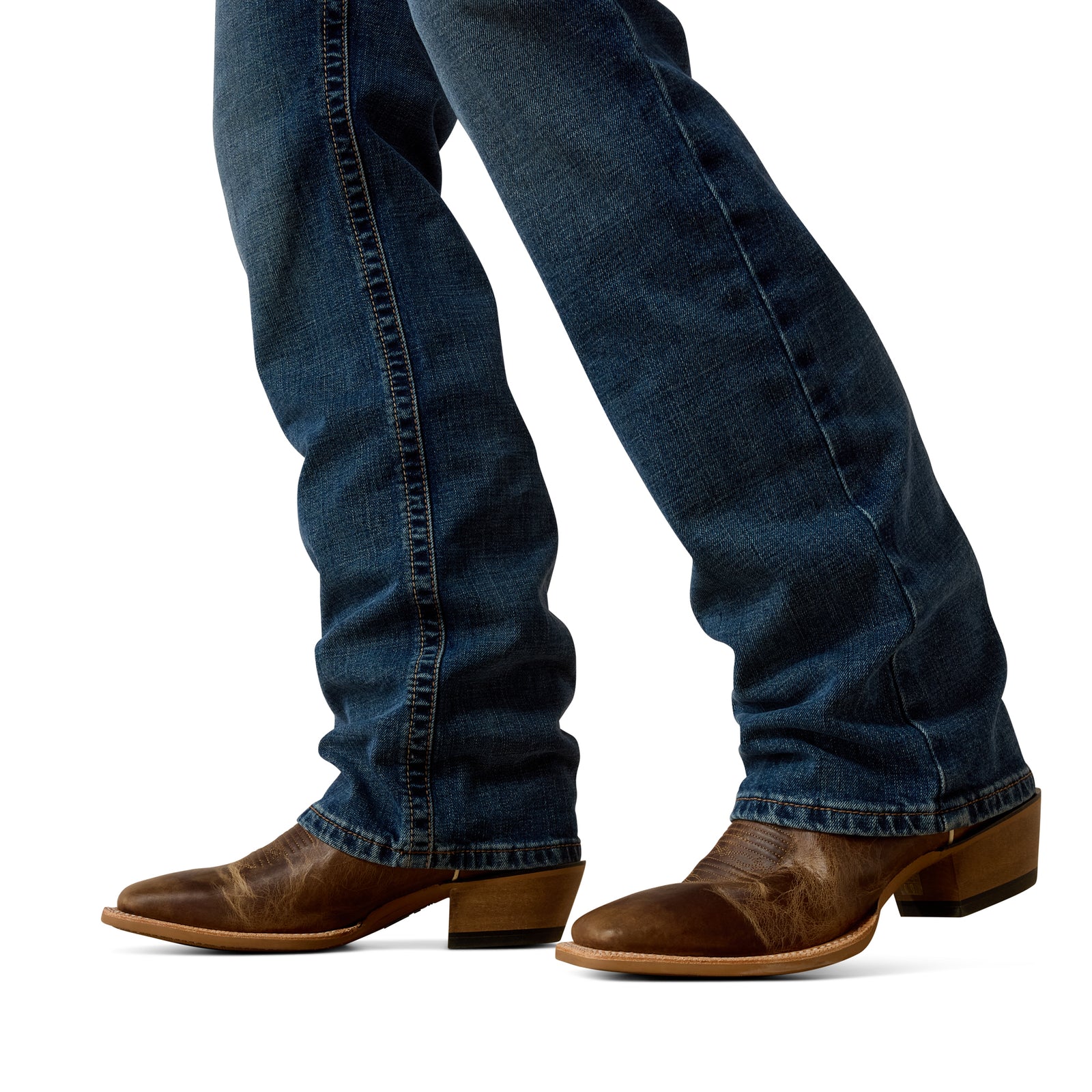 Blue jeans and brown cowboy boots on a white background