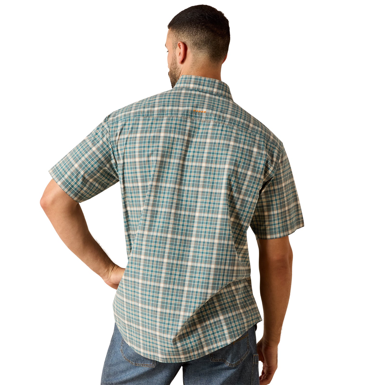 A man viewed from the back wearing a short-sleeve plaid button-up shirt in teal, beige, and white, paired with blue jeans against a plain white background.