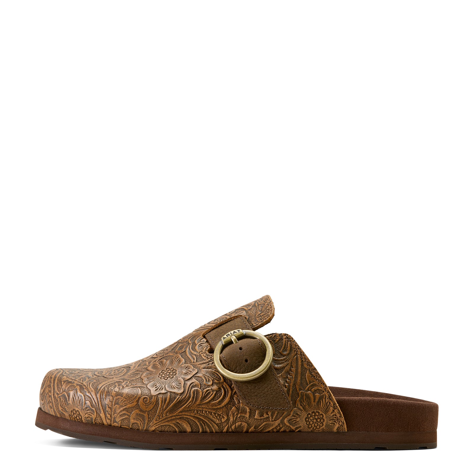 Brown leather clog shoe with floral embossing and a round buckle on a white background