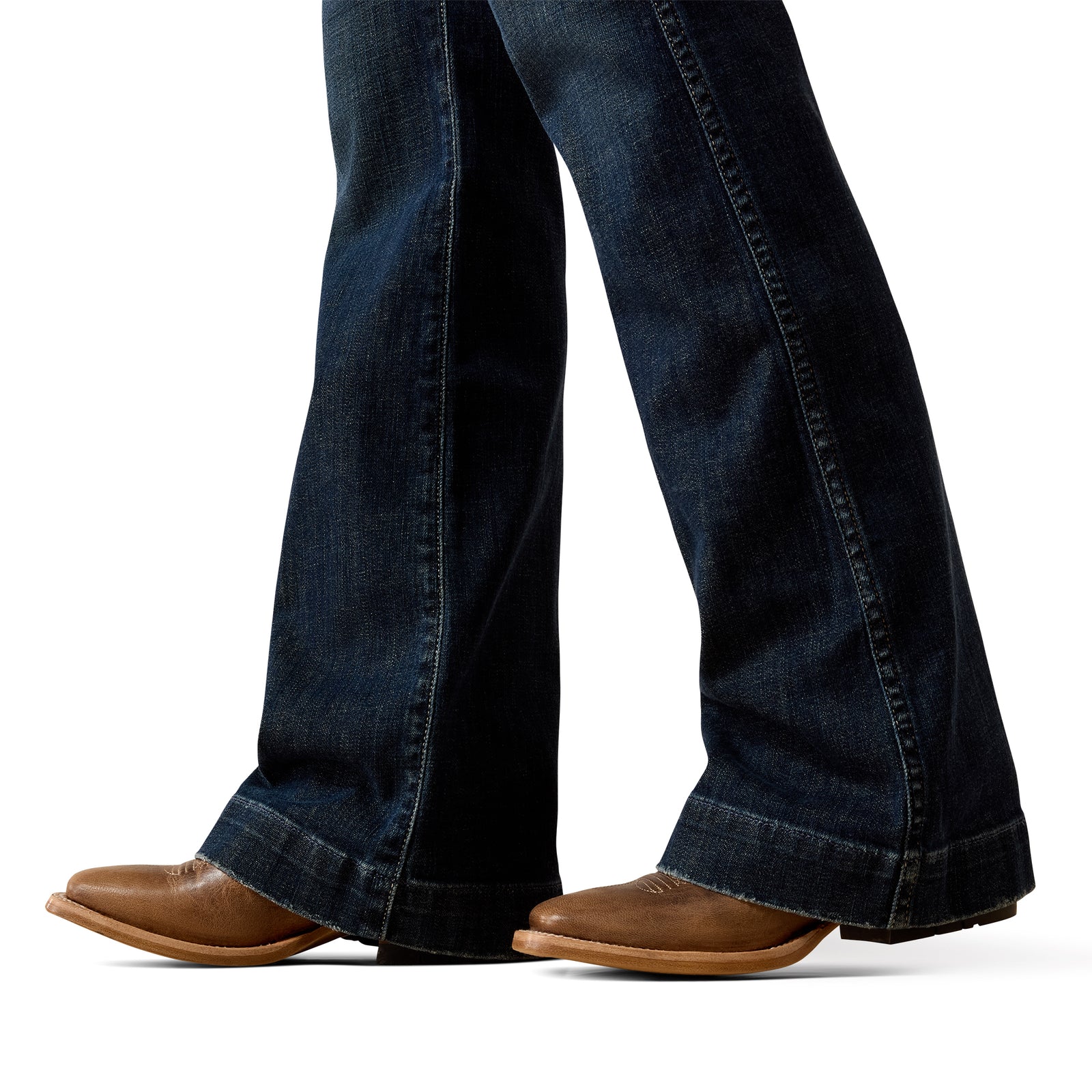 Dark blue jeans worn by a person on a white background