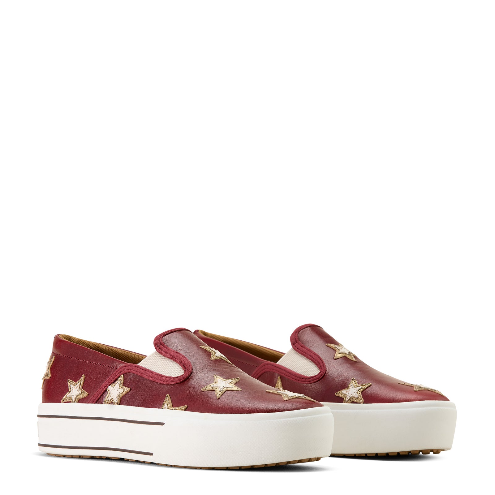 Red slip-on sneakers with gold star details on a white background