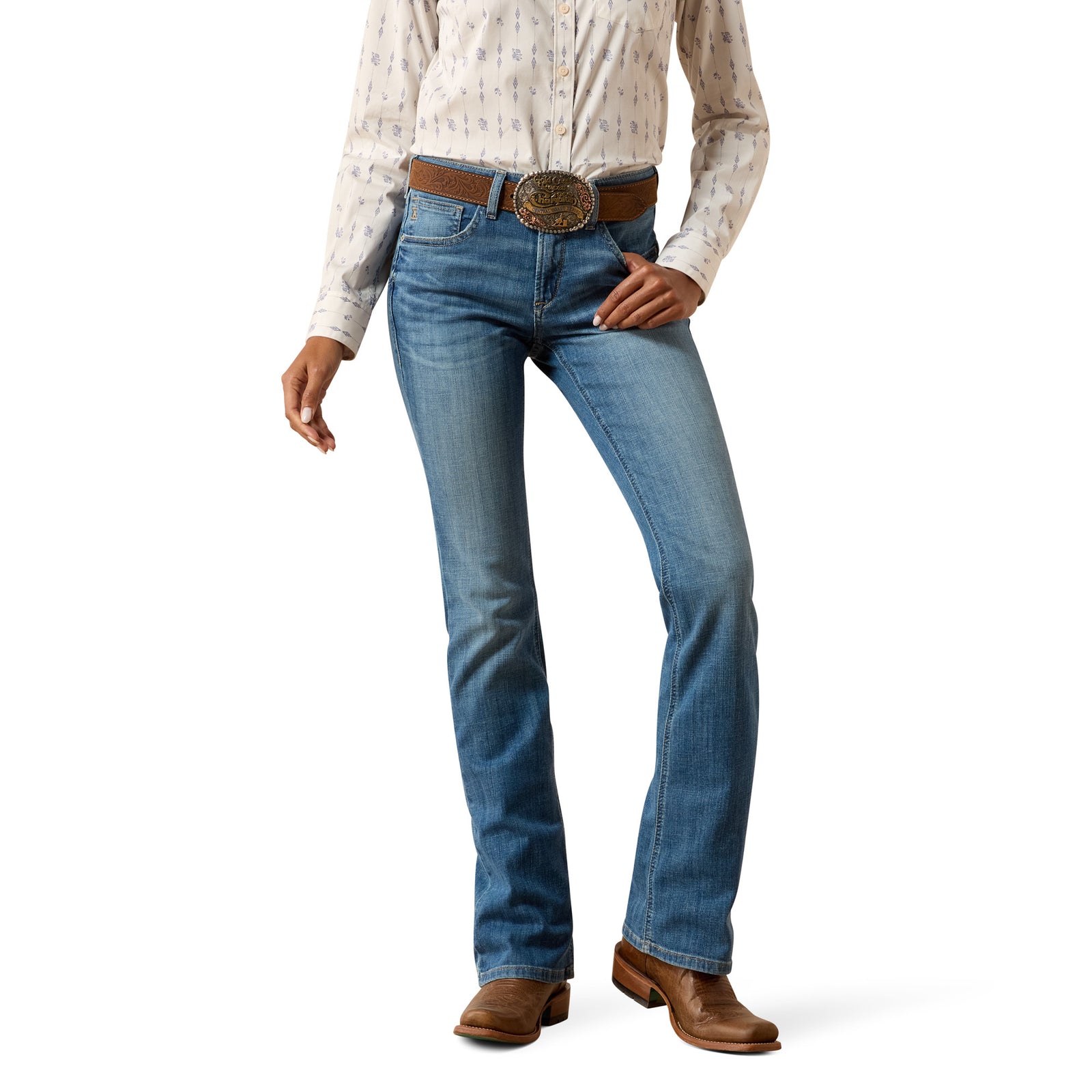 Person wearing blue jeans and a patterned shirt on a white background