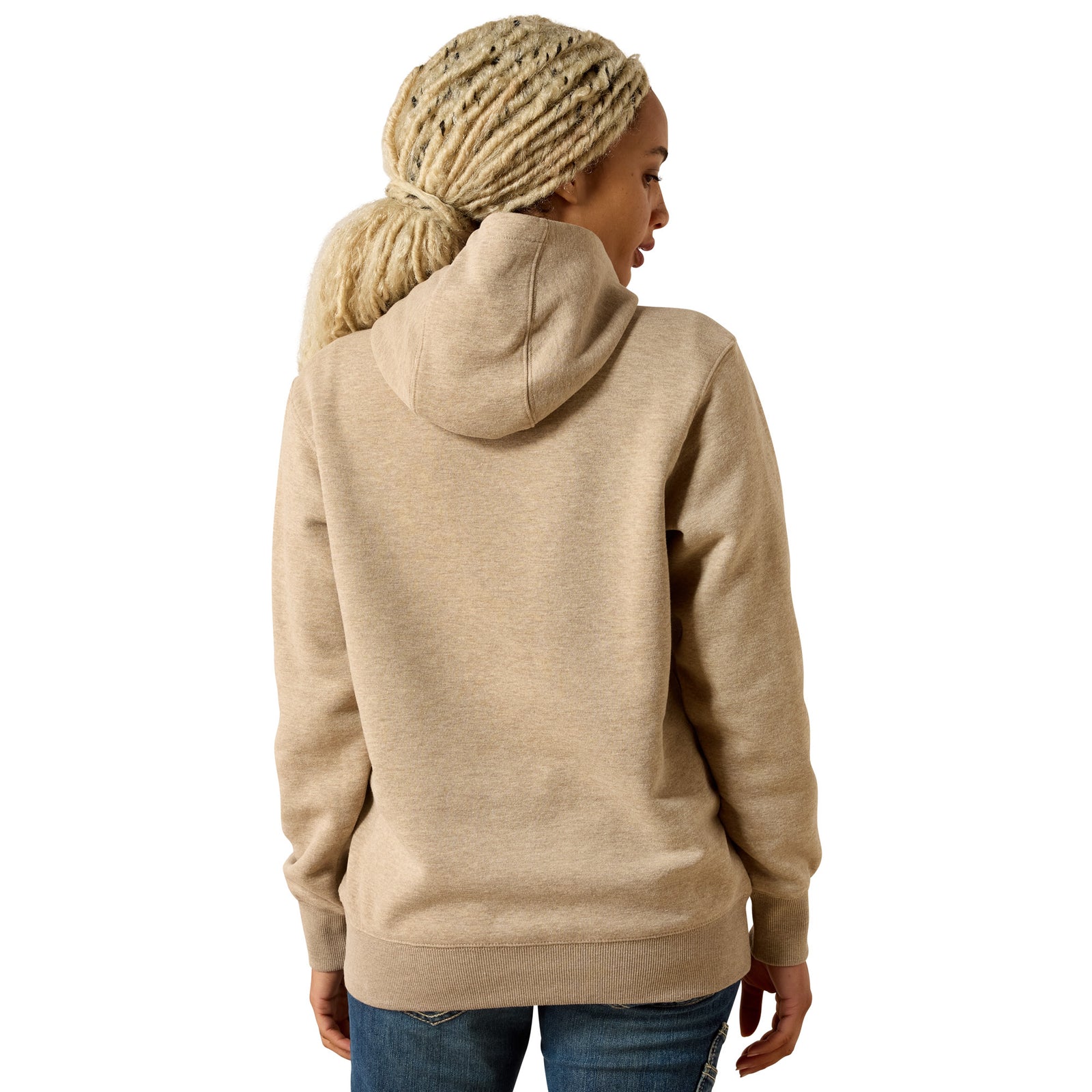 A woman with blonde braids is shown from the back wearing a light beige heathered pullover hoodie and blue jeans against a plain white background.