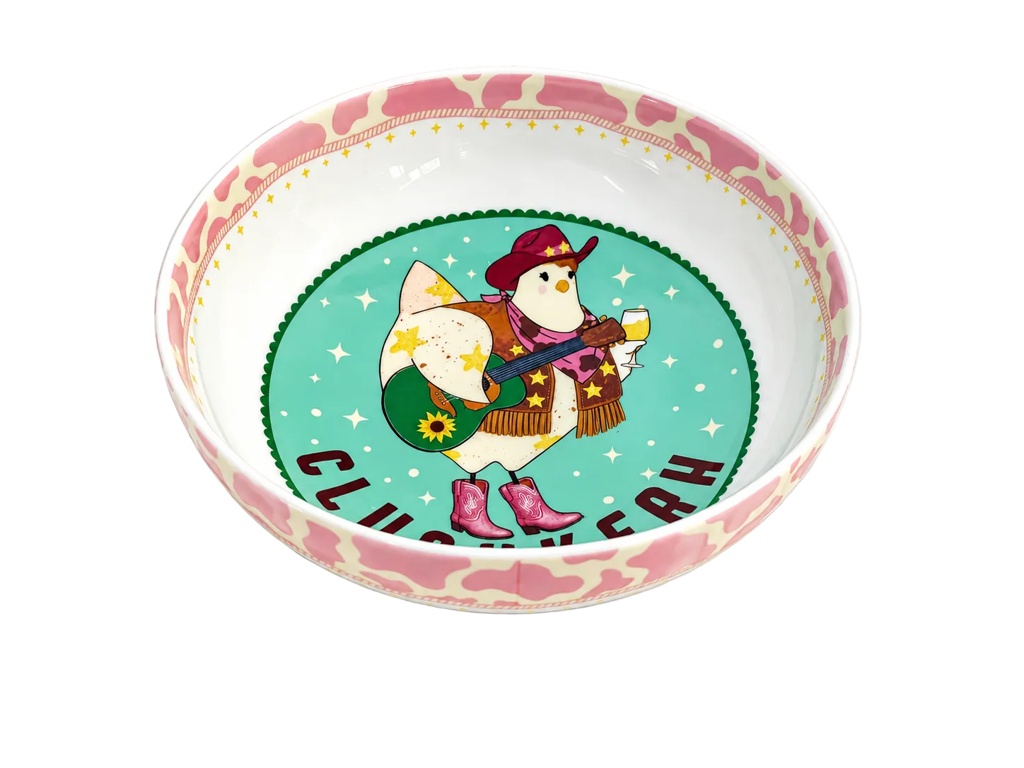 A ceramic bowl with a pink and cream cow-print patterned rim, featuring a colorful central illustration of a penguin in cowboy boots and hat on a turquoise background with the text 'CLIMB THE HANG'.