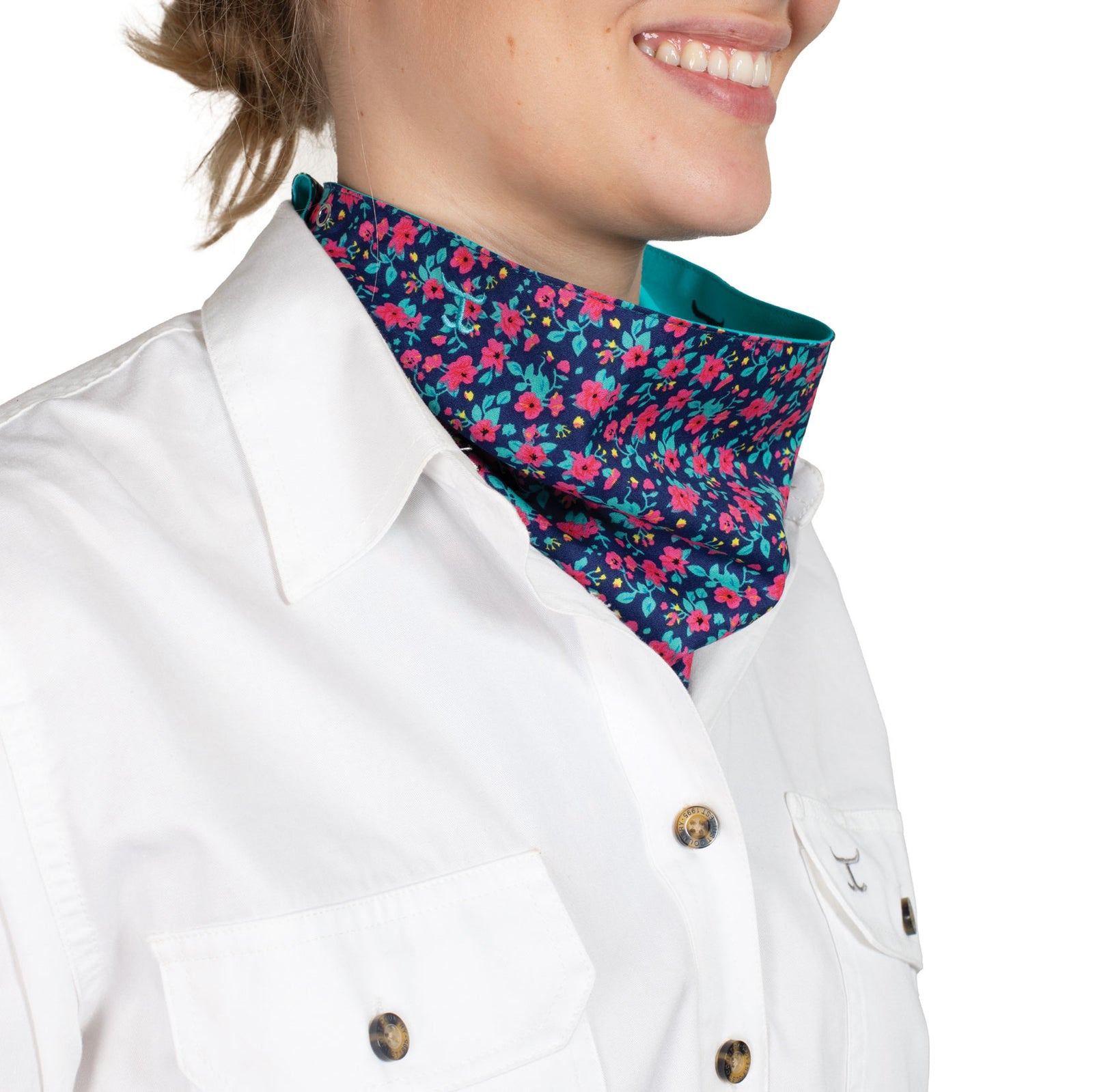 Just Country Carlee Double Sided Scarf. Person wearing a colorful floral neck gaiter over a white shirt with gold buttons.