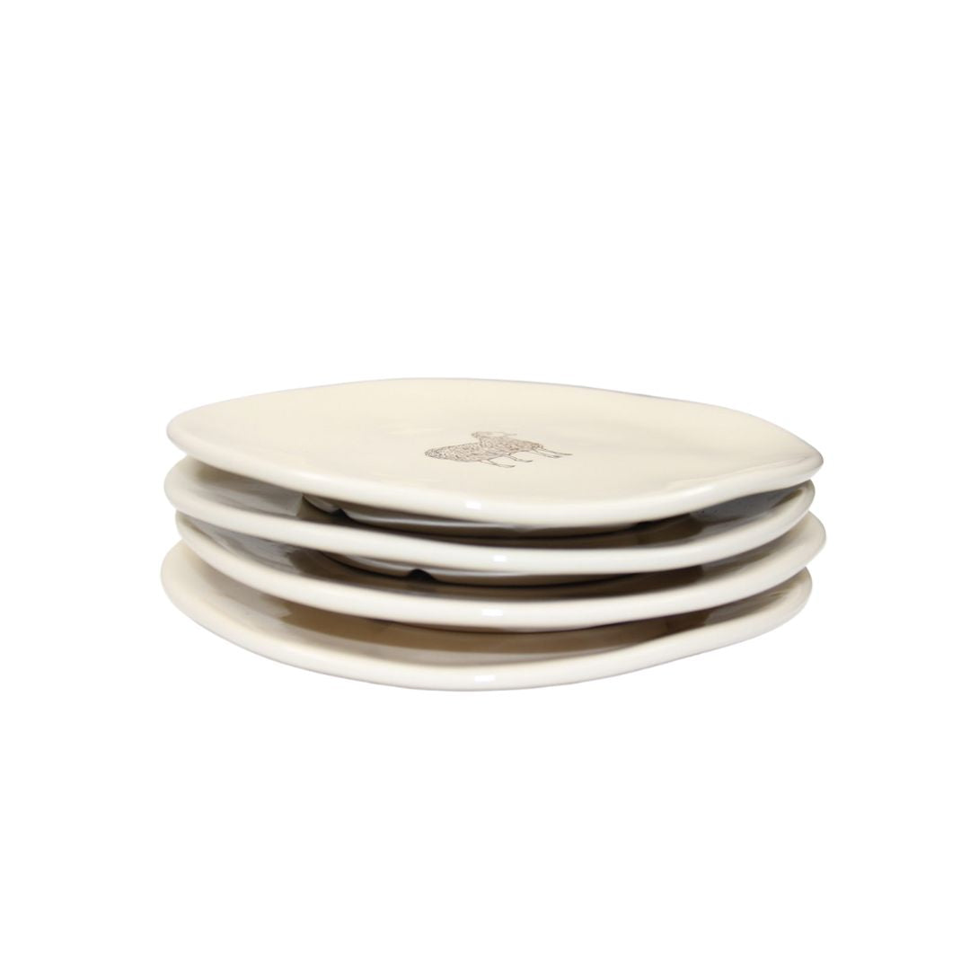 Farm Design Set of 4 Small Ceramic Plates. Set of four white ceramic plates stacked on a white background