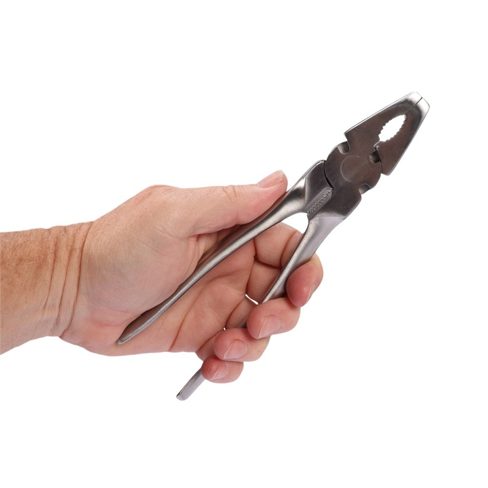 A hand holding a pair of silver metal pliers against a plain white background.