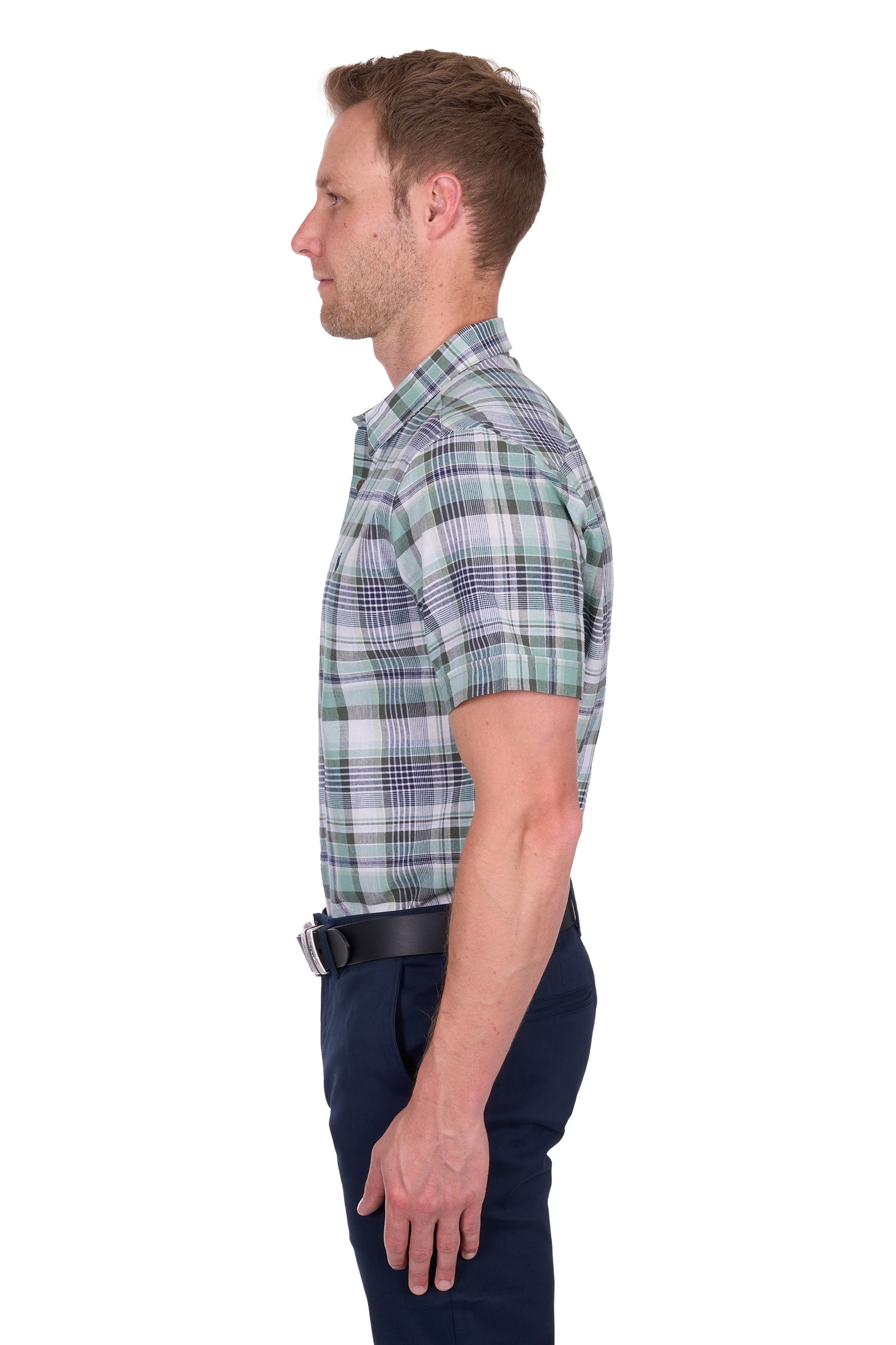 Side view of a man wearing a Thomas Cook Men's Gerry Linen S/S Shirt. Green and navy plaid shirt and navy pants on a white background