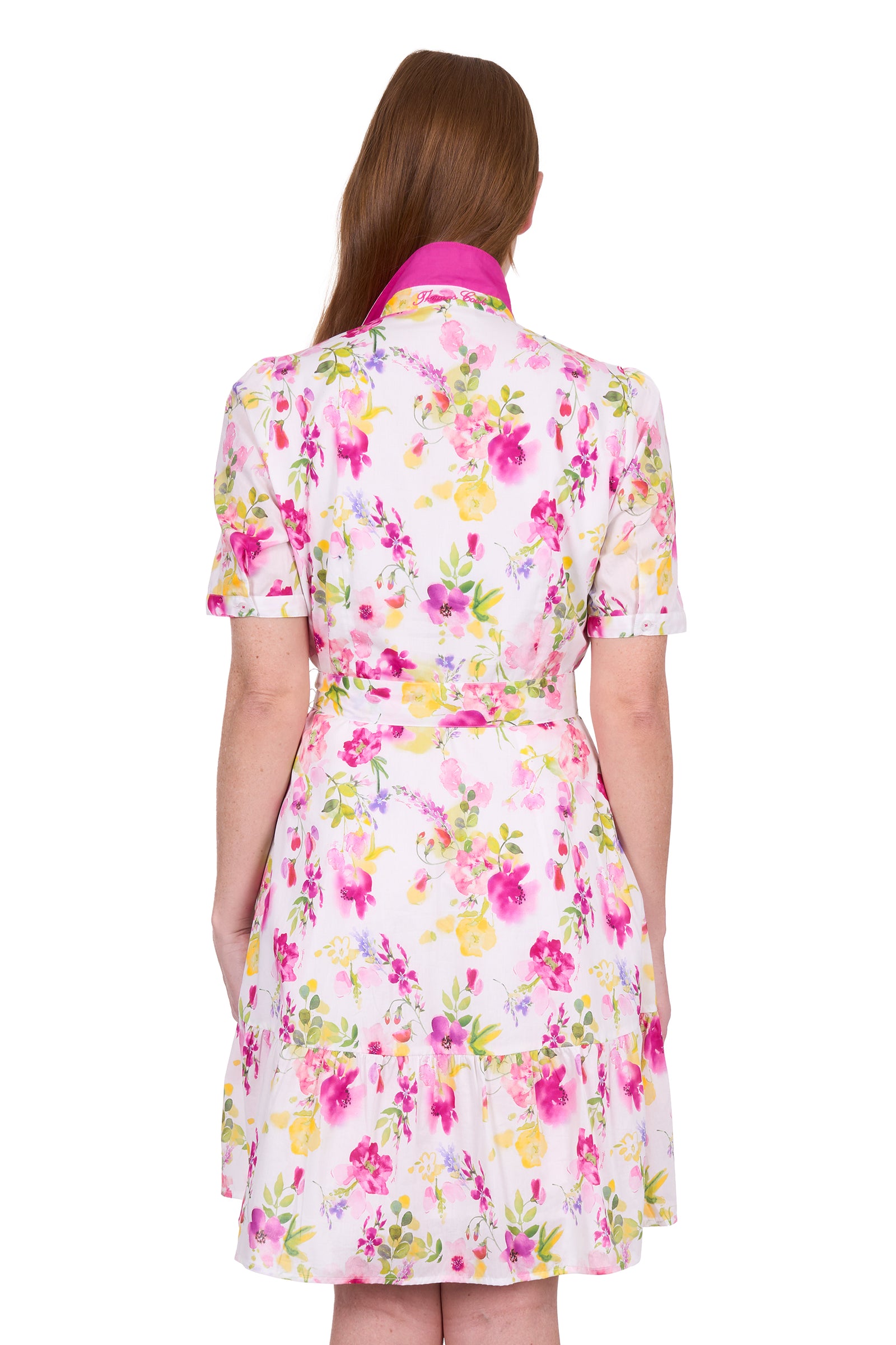 Thomas Cook Women's Flora S/S Dress. Woman wearing a floral dress on a white background