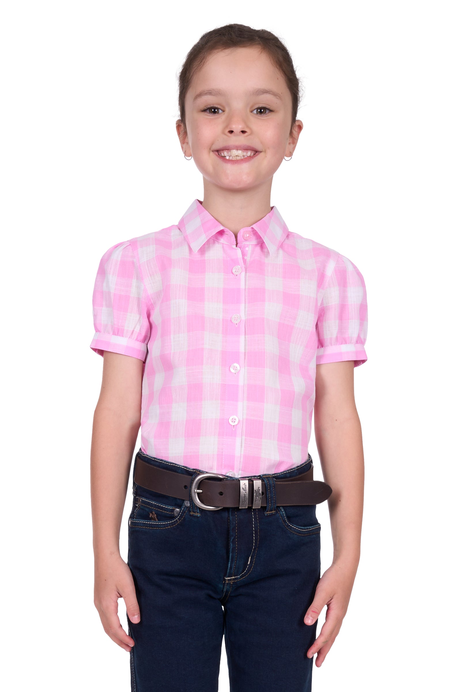 Thomas Cook Girl's Eliza S/S Shirt. Young girl wearing a pink checkered shirt and dark jeans on a white background