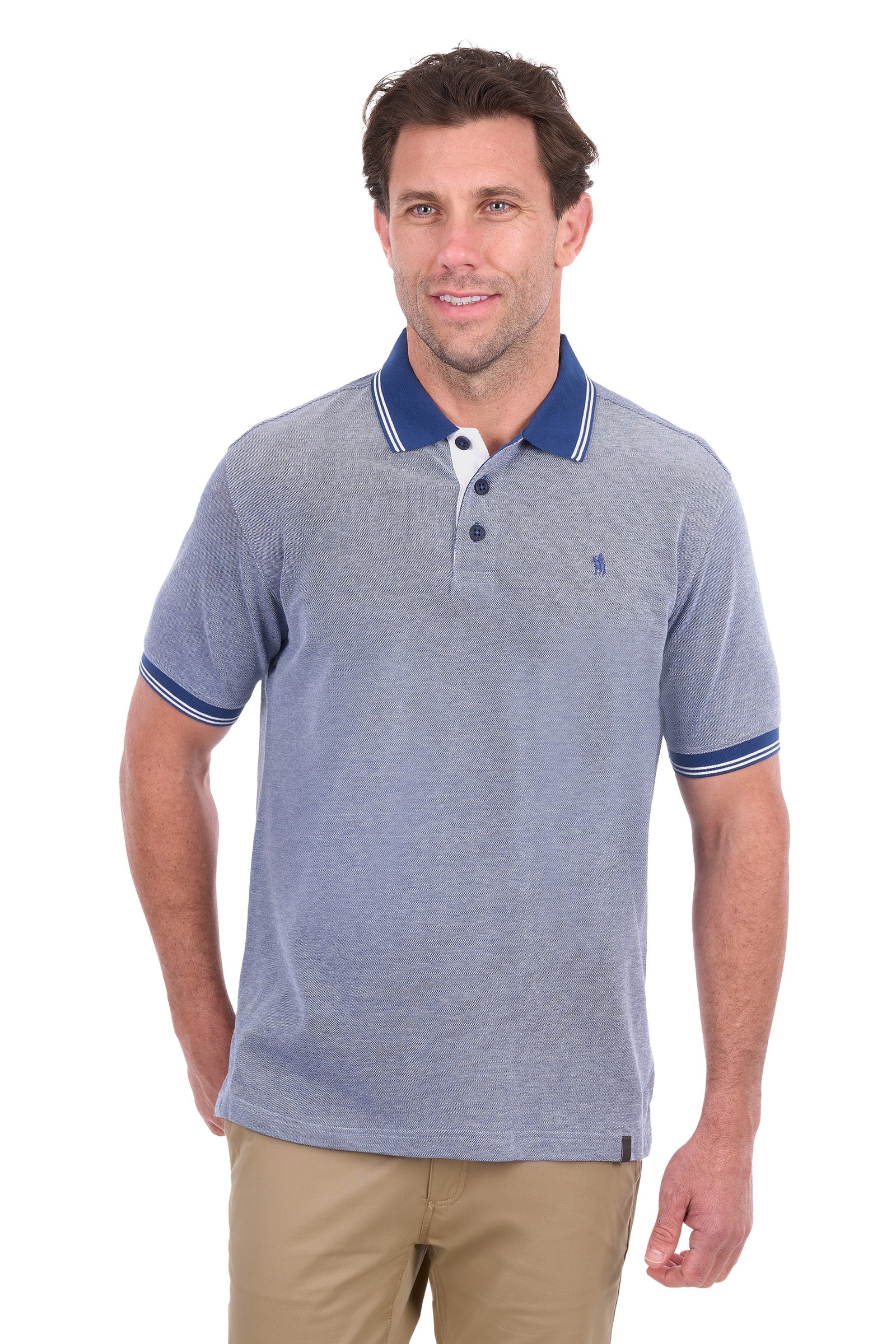A man wearing a heathered blue polo shirt with a navy blue collar and sleeve trim, paired with khaki pants, against a plain white background.