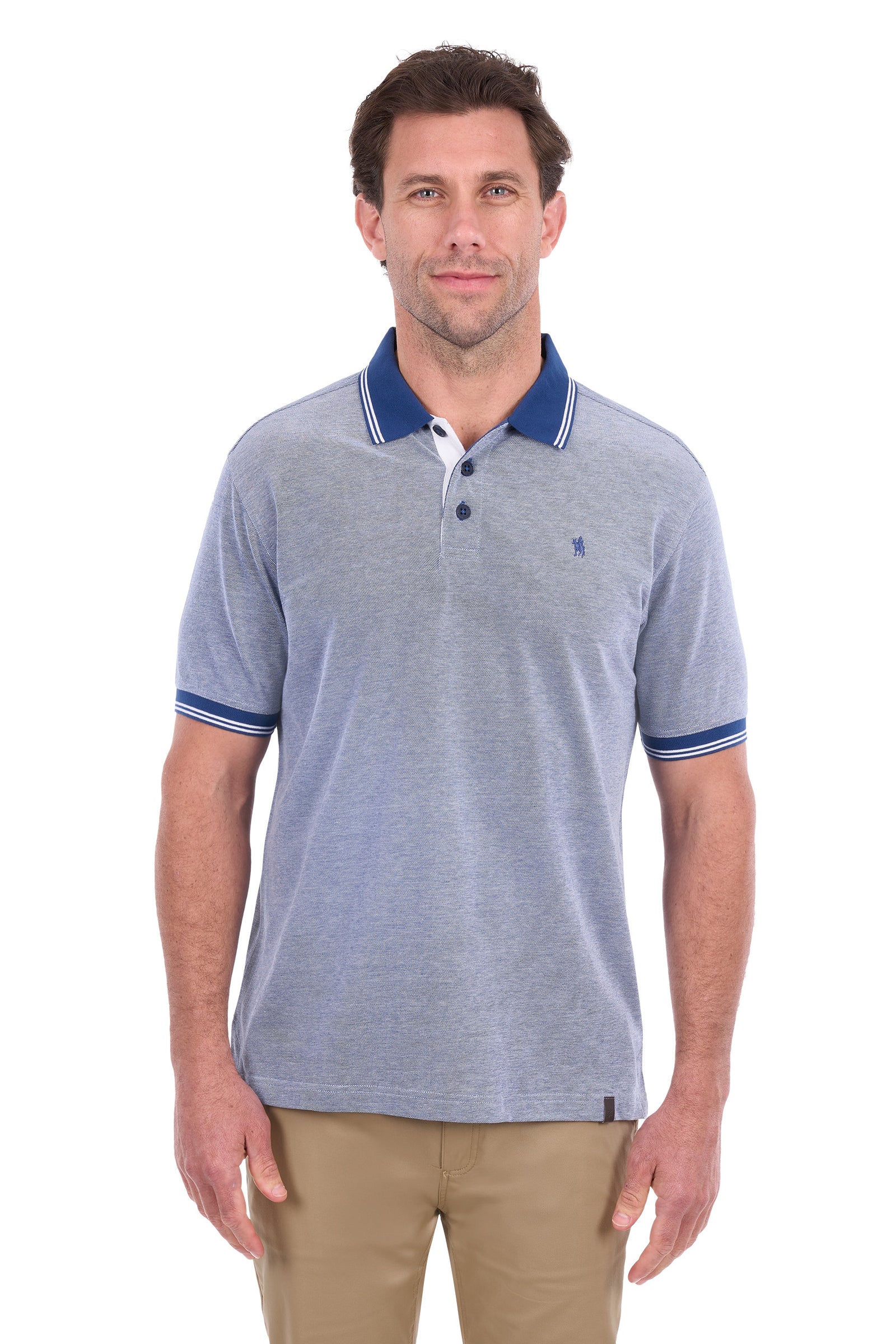 A man wearing a light heather gray polo shirt with a navy blue collar and sleeve trim, paired with khaki pants, against a plain white background.