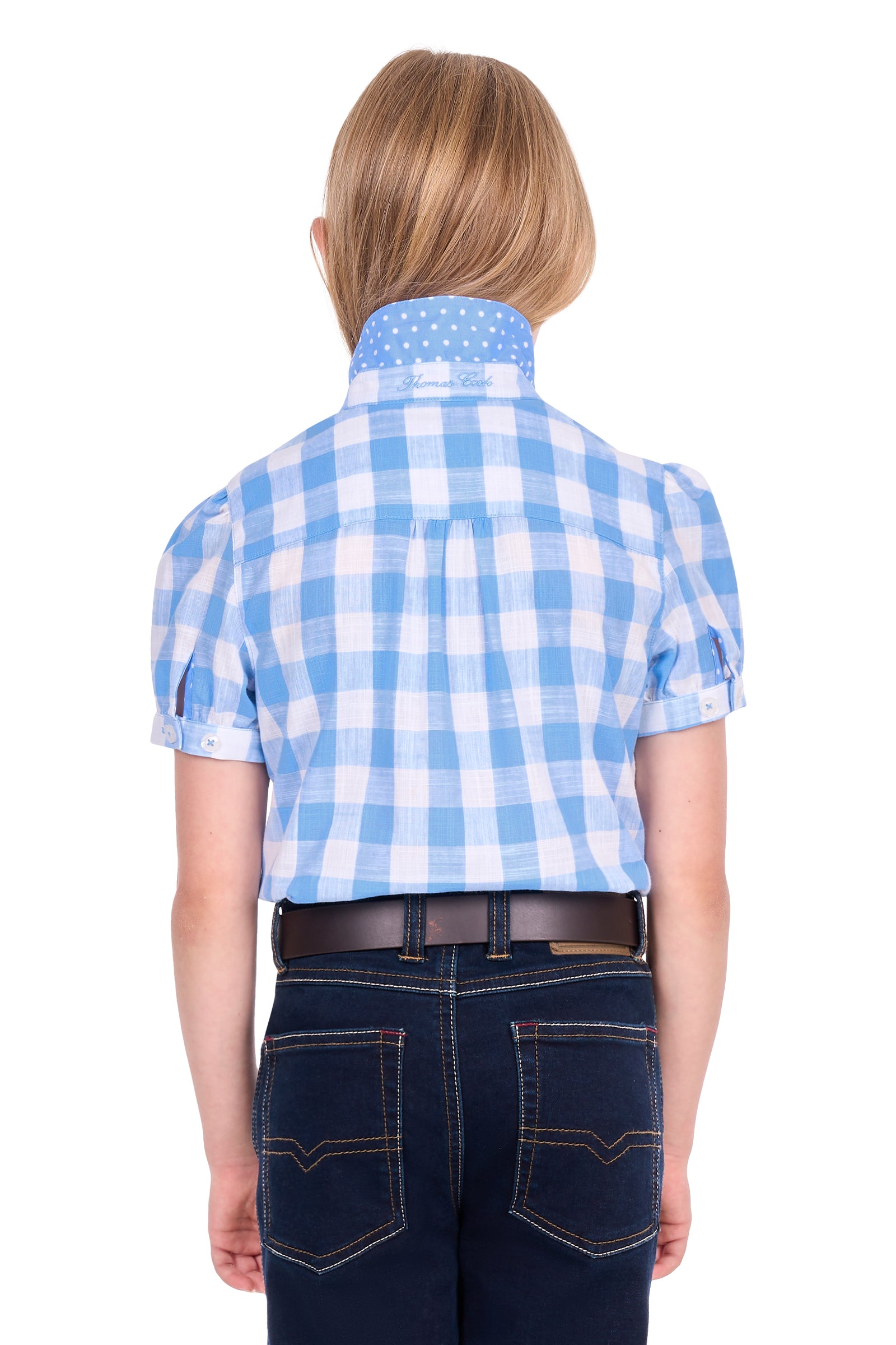 A child viewed from the back wearing a light blue and white gingham short-sleeve button-up shirt, dark blue jeans, and a brown belt, against a plain white background.