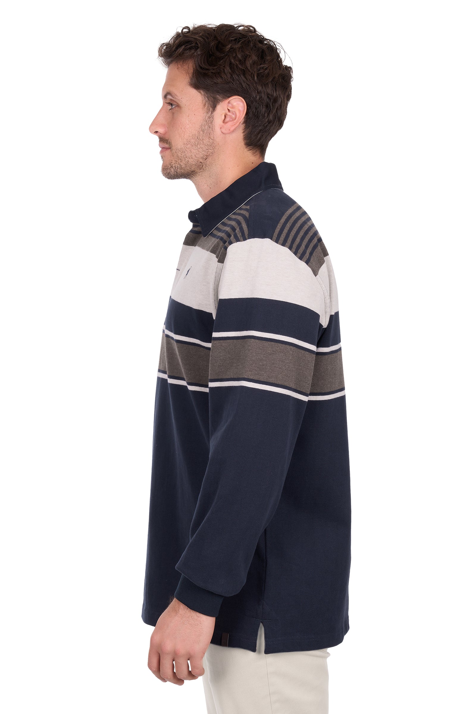 Man wearing a navy, white, and brown striped sweater on a white background