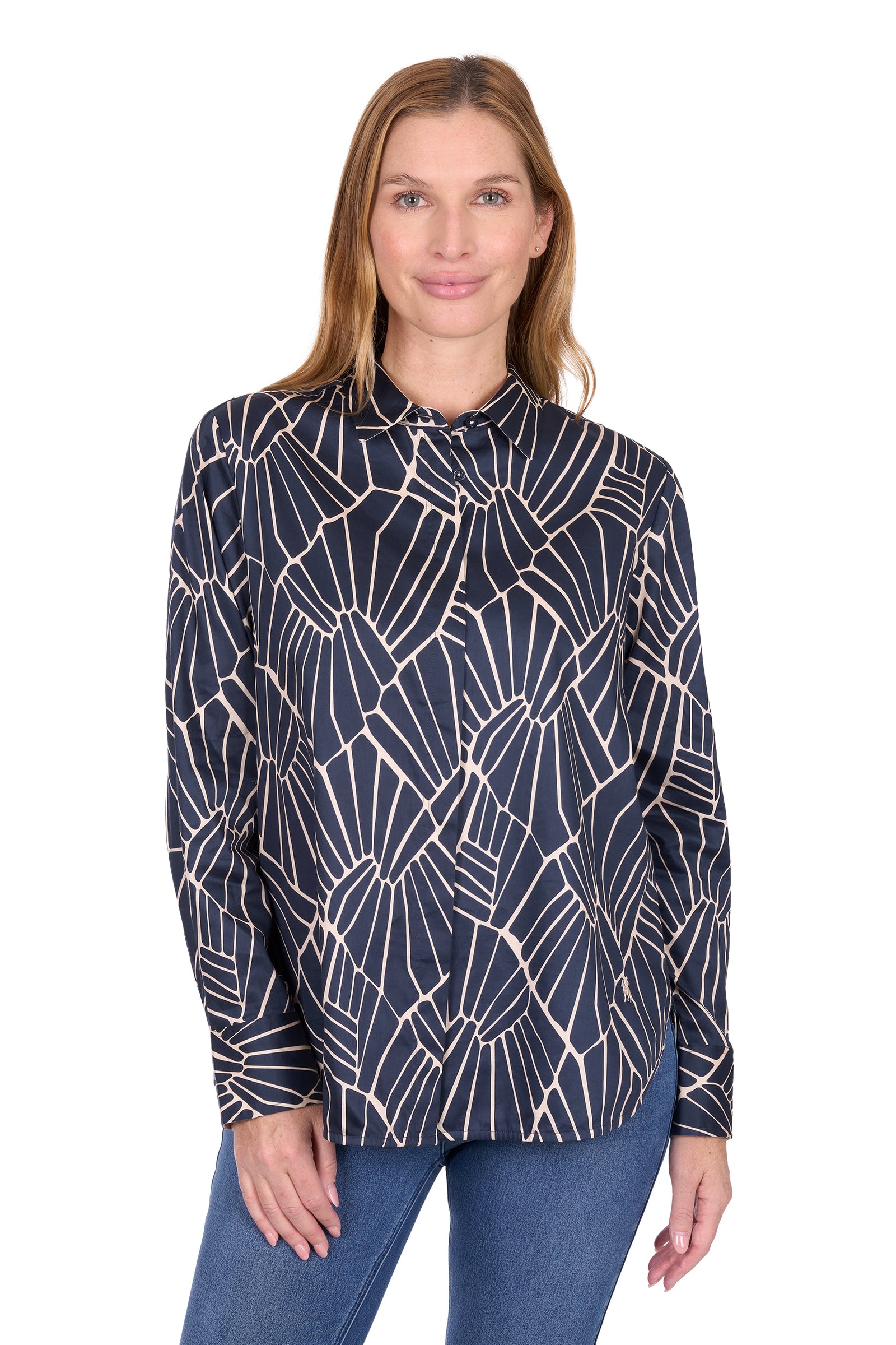 Woman wearing a navy blue blouse with white geometric pattern on a white background