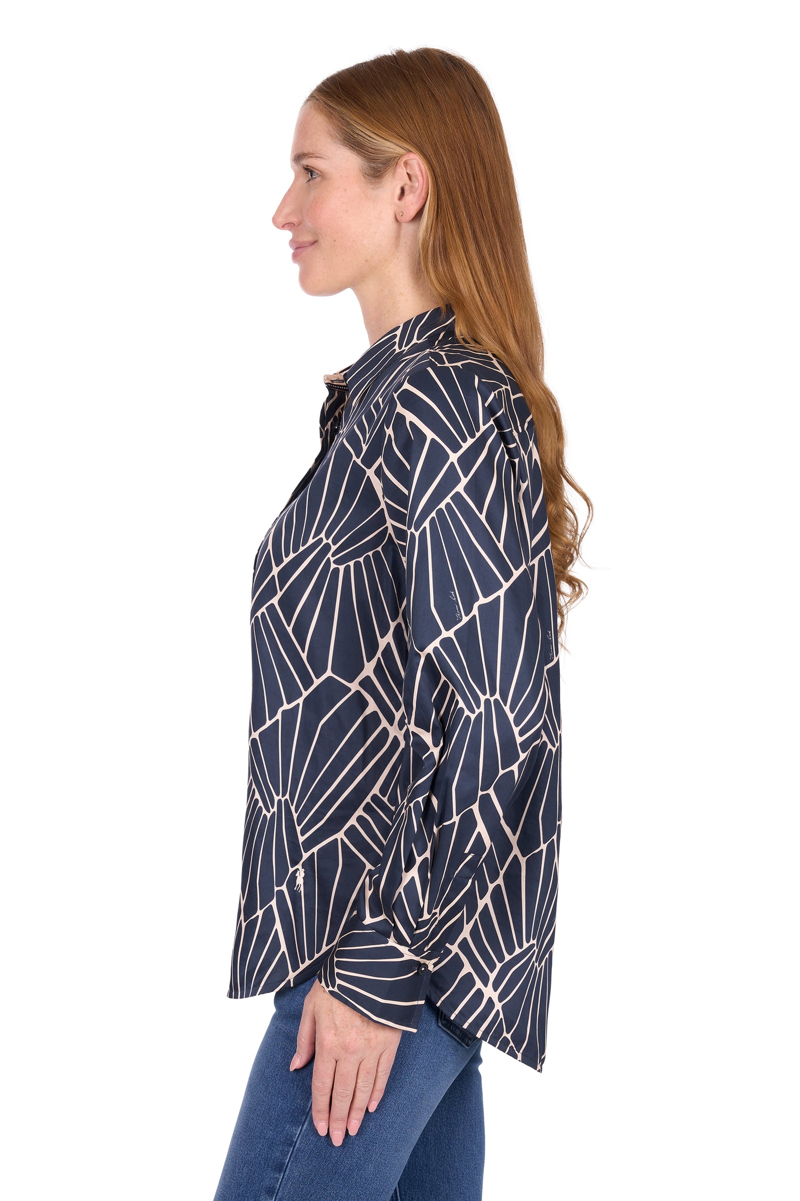 Woman wearing a navy blue patterned shirt on a white background