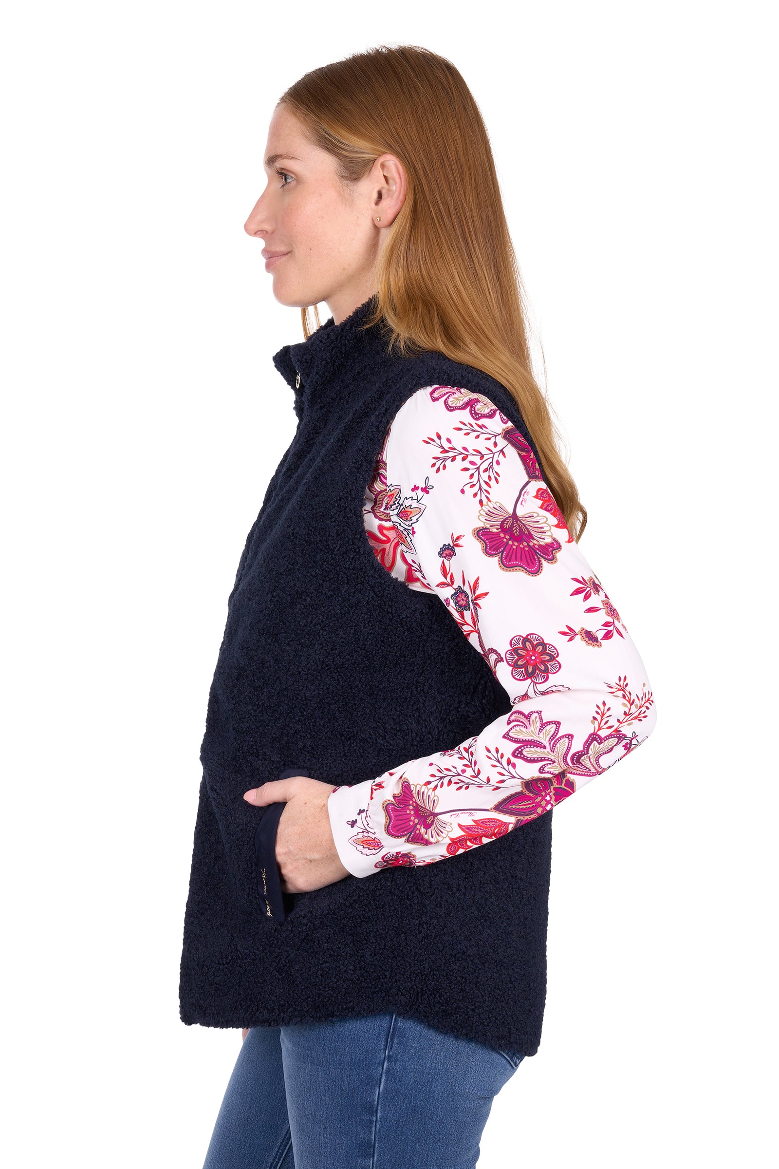 Woman wearing a dark blue vest with floral sleeves on a white background