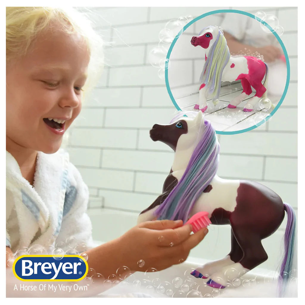Breyer Activity Marina Bath Time Colour Change Mer-Pony. Child playing with a Breyer horse toy in a bathtub, with the Breyer logo visible.