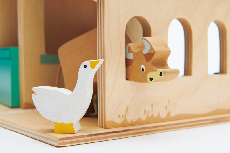 Kaleidoscope Tender Leaf Farm. Wooden toy with animal cutouts and a goose figure on a white background