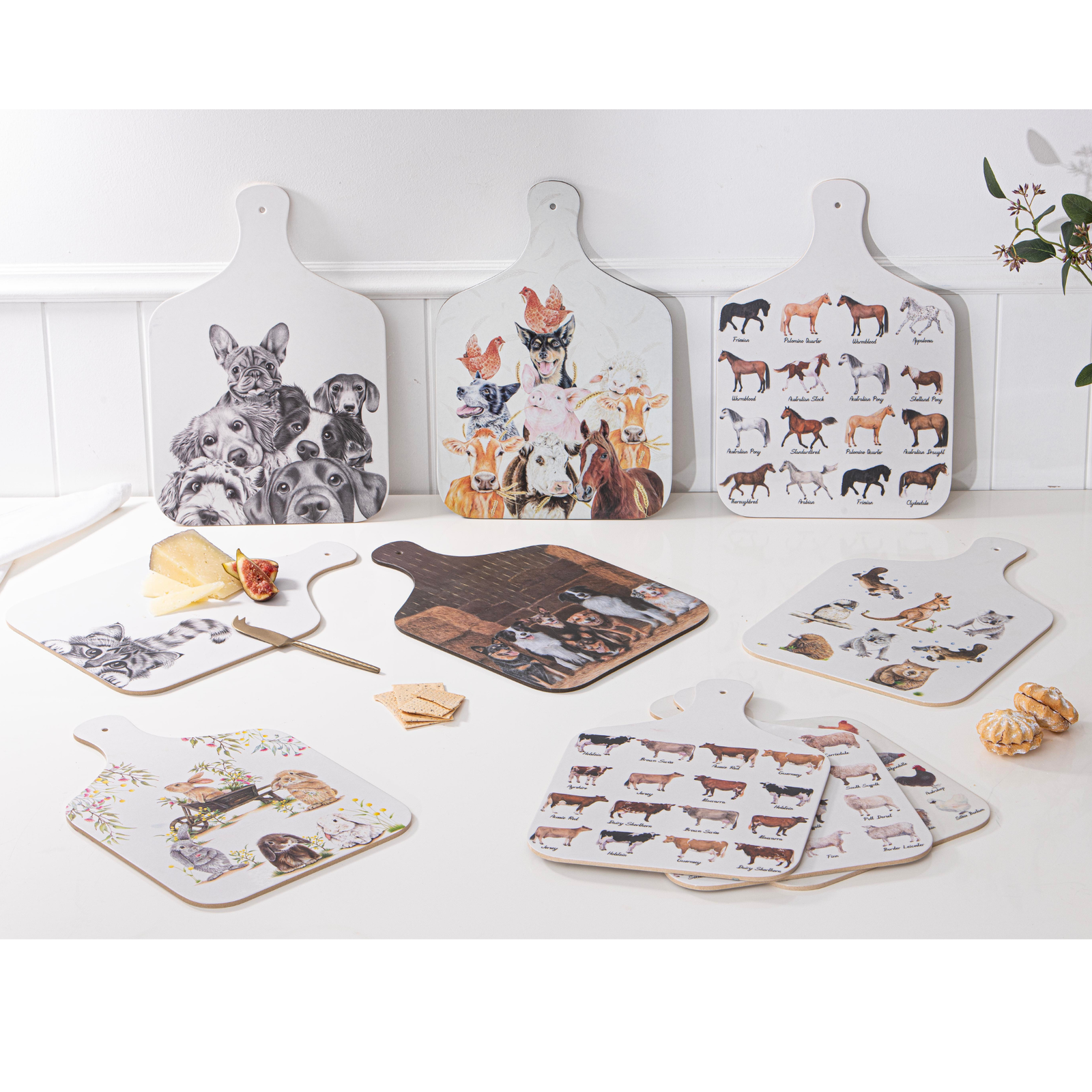 Set of cutting boards with animal illustrations on a white surface