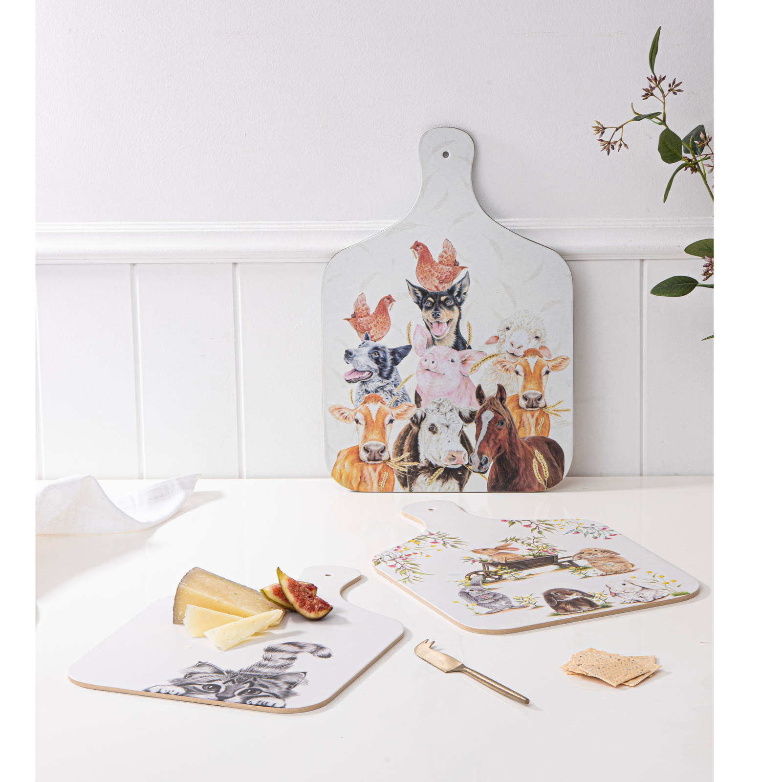 Set of decorative cutting boards with animal illustrations on a white surface.