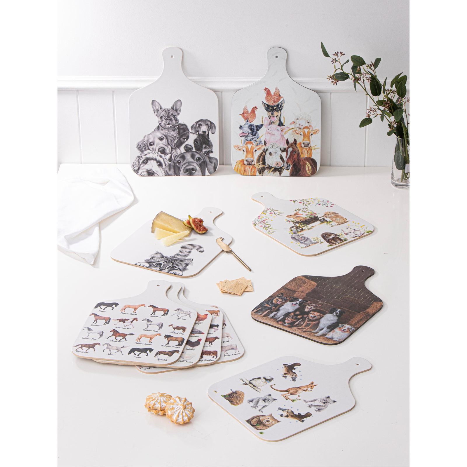 Set of cutting boards with animal illustrations on a white surface.