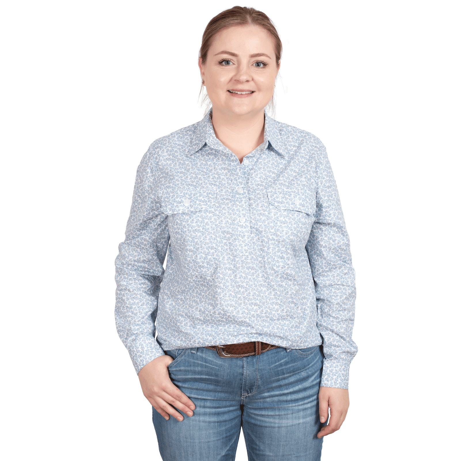 Just Country Women's Georgie Half Button L/S Shirt. A woman standing, wearing a blue floral long-sleeve shirt and blue jeans.