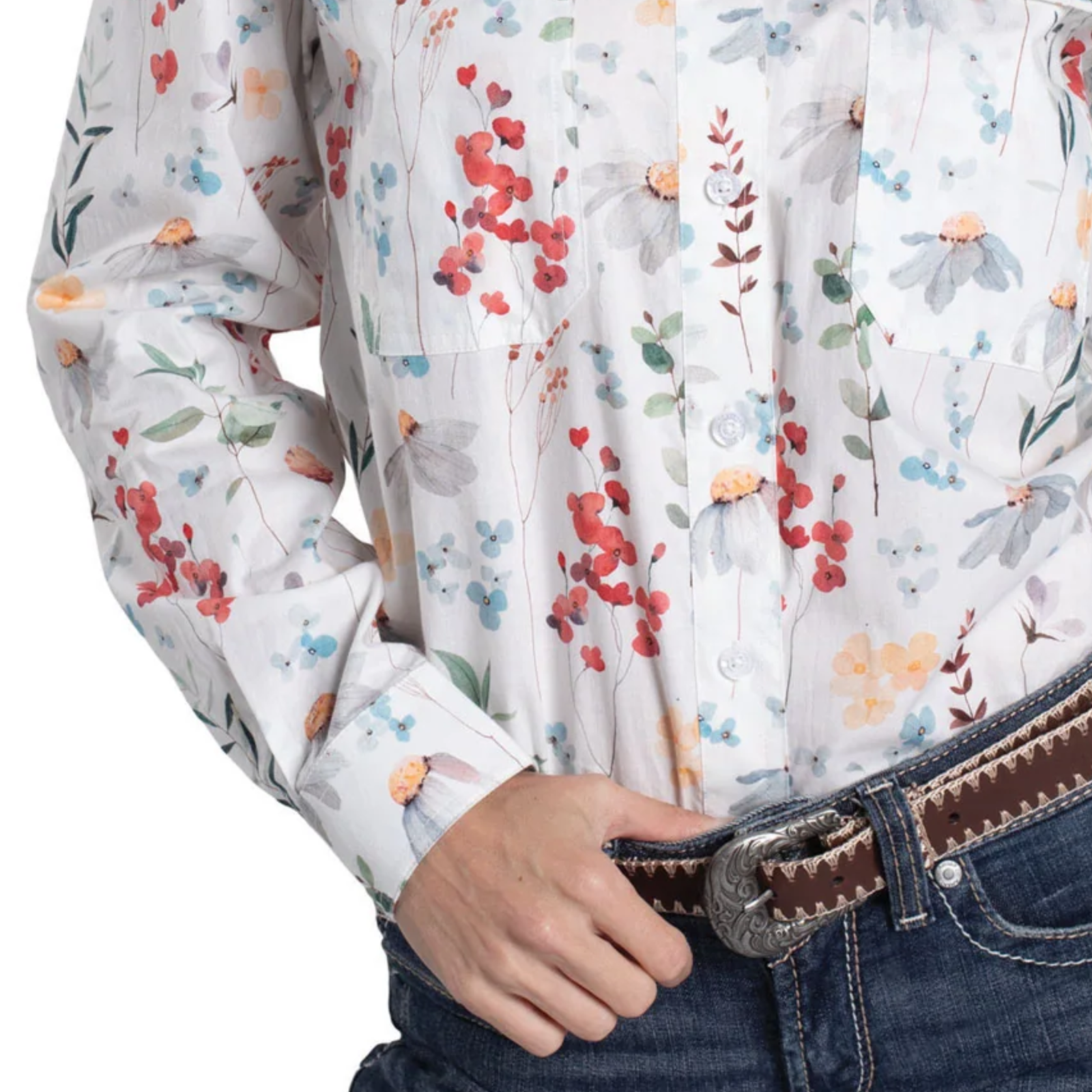 Close-up of a person wearing a floral-patterned shirt with rolled-up sleeves and jeans.