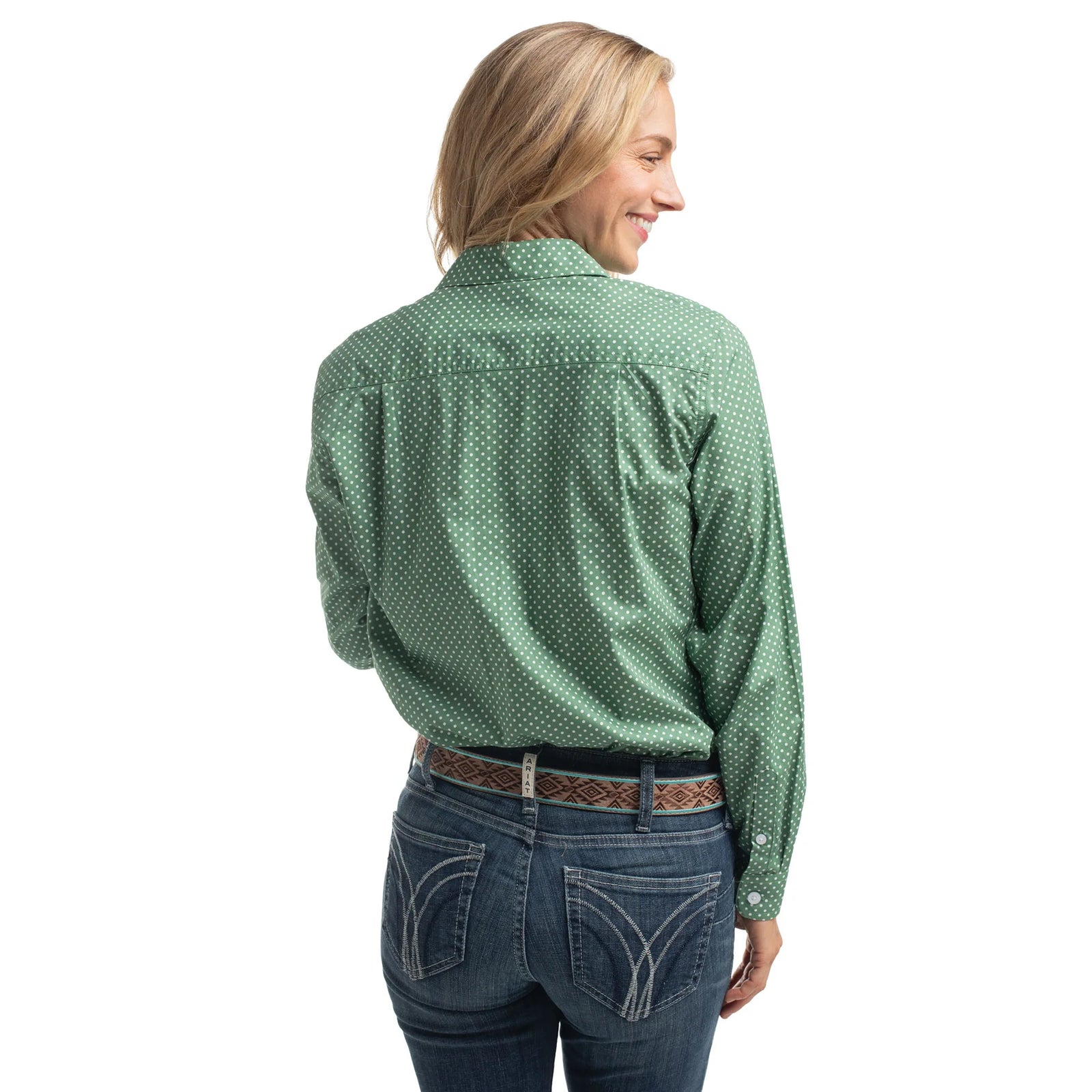 Woman wearing a green patterned shirt and blue jeans on a white background