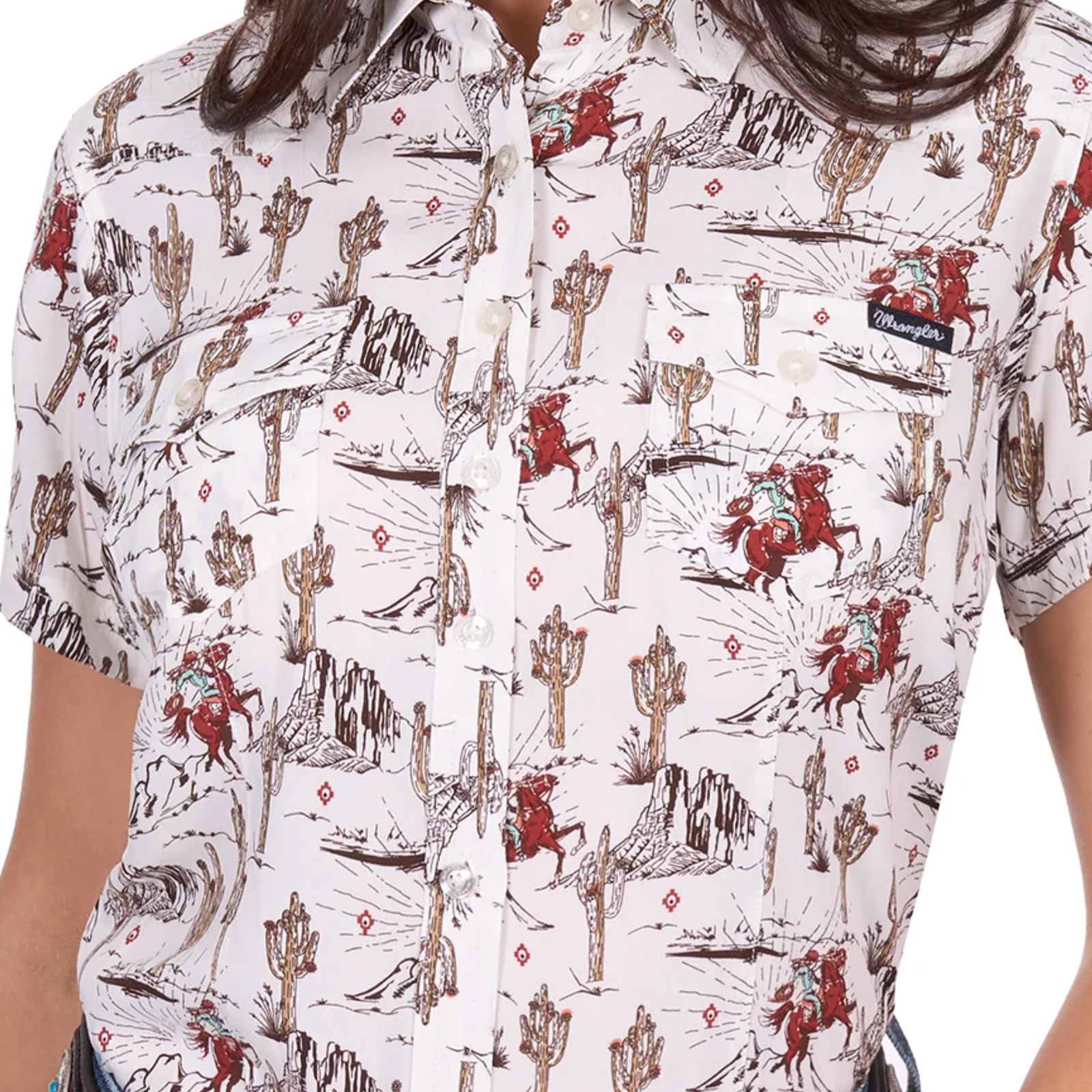 Wrangler Women's Celeste S/S Western Shirt. Person wearing a white shirt with a red and brown pattern of horses and landscapes.