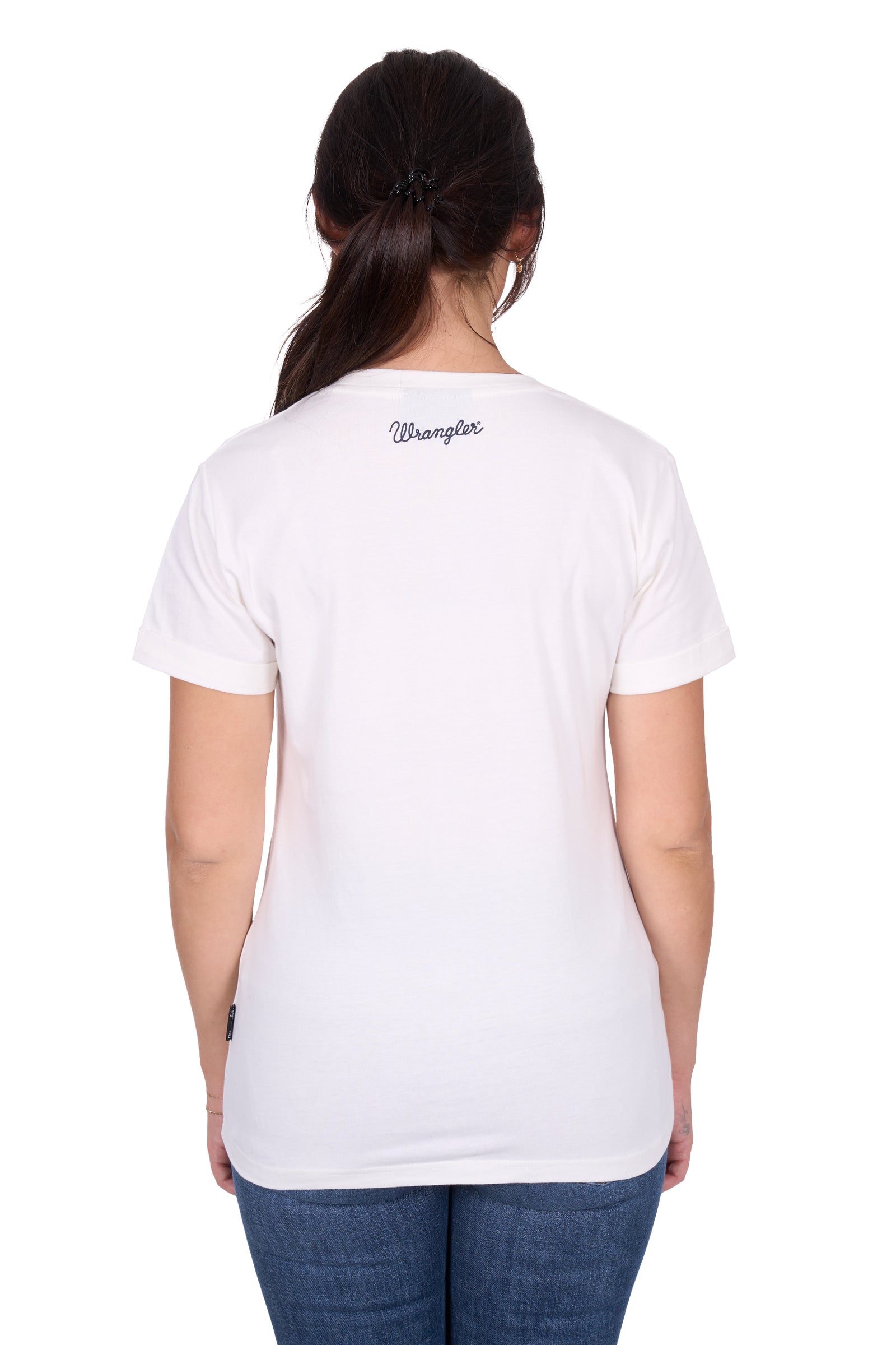 Wrangler Women's Piper S/S T-Shirt. Person wearing a white t-shirt with 'Wrangler' branding on the back, standing against a white background.