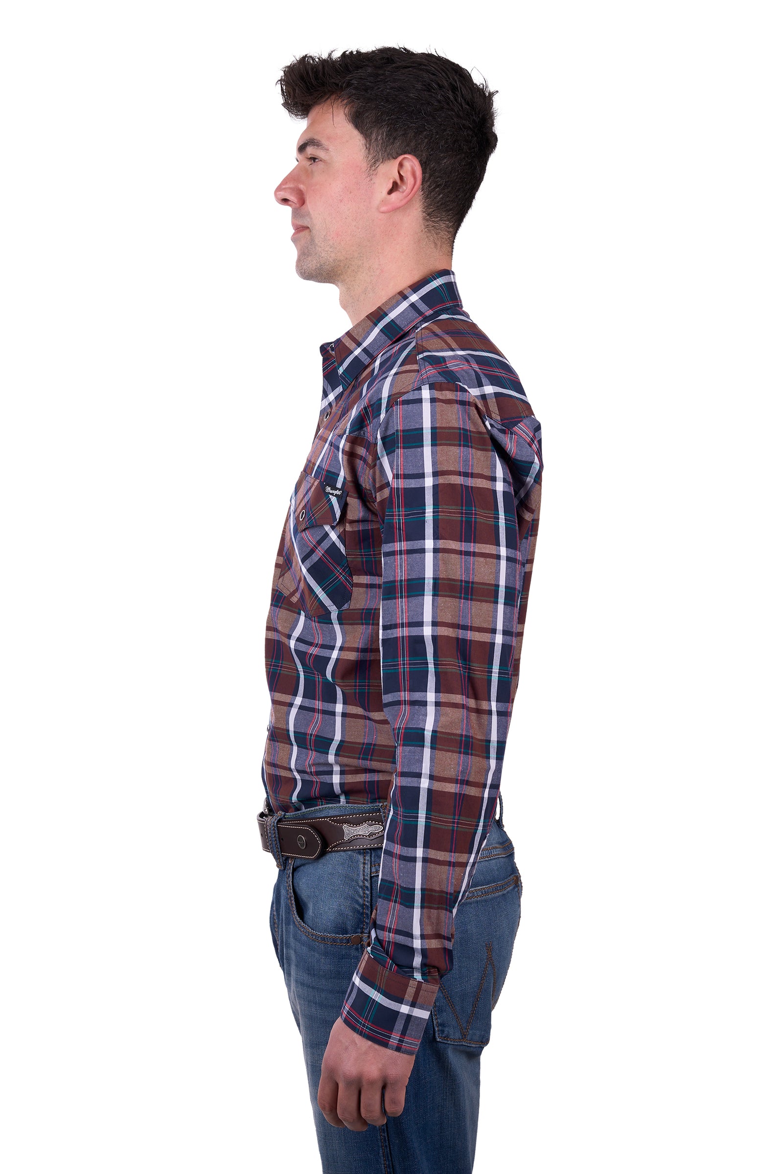 A man wearing a long sleeve plaid Wrangler Men's Milo Western Shirt in brown, blue, and white check, with western chest pockets and a western yoke.