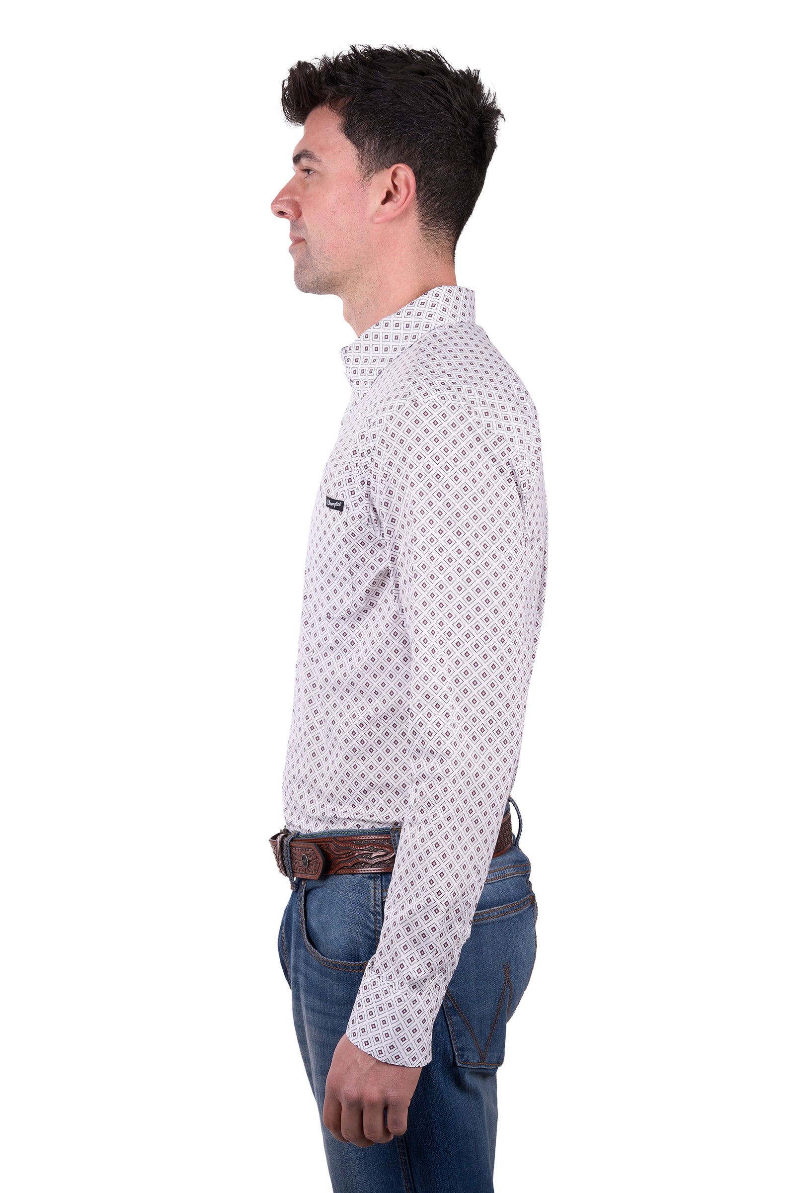 A man wearing a long-sleeved, button-down, checkered white and blue Wrangler Men's Knox Western Shirt with a pointed collar, paired with blue jeans and a brown belt.