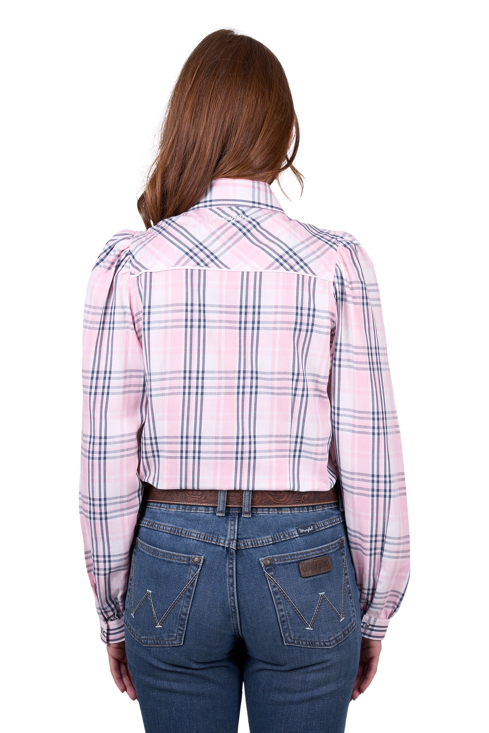 A woman wearing a wrangler western checked western shirt with paired with blue jeans.